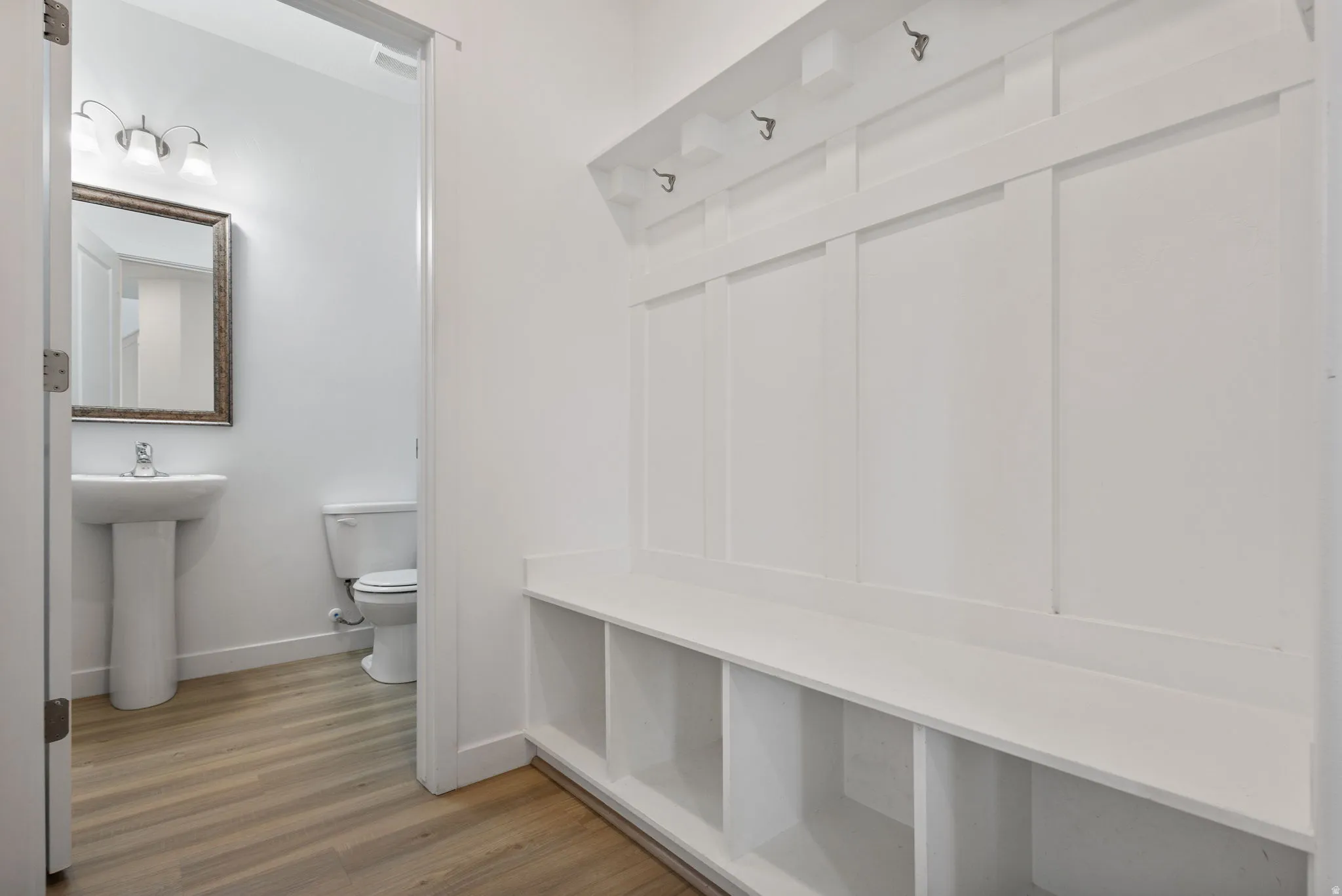 Mudroom featuring decorative board and batten storage area