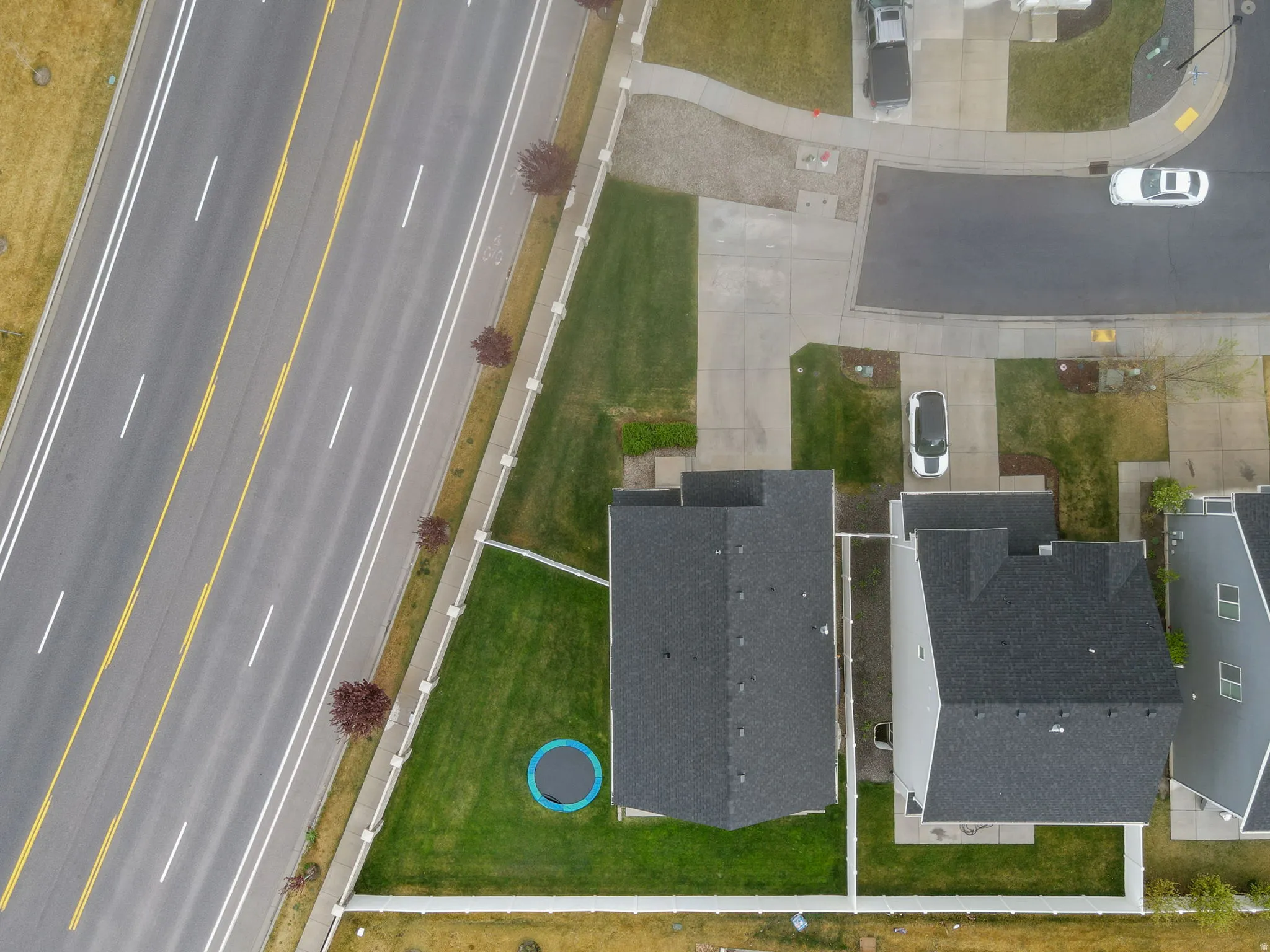 Aerial view of large yard and spacious driveway with extra parking