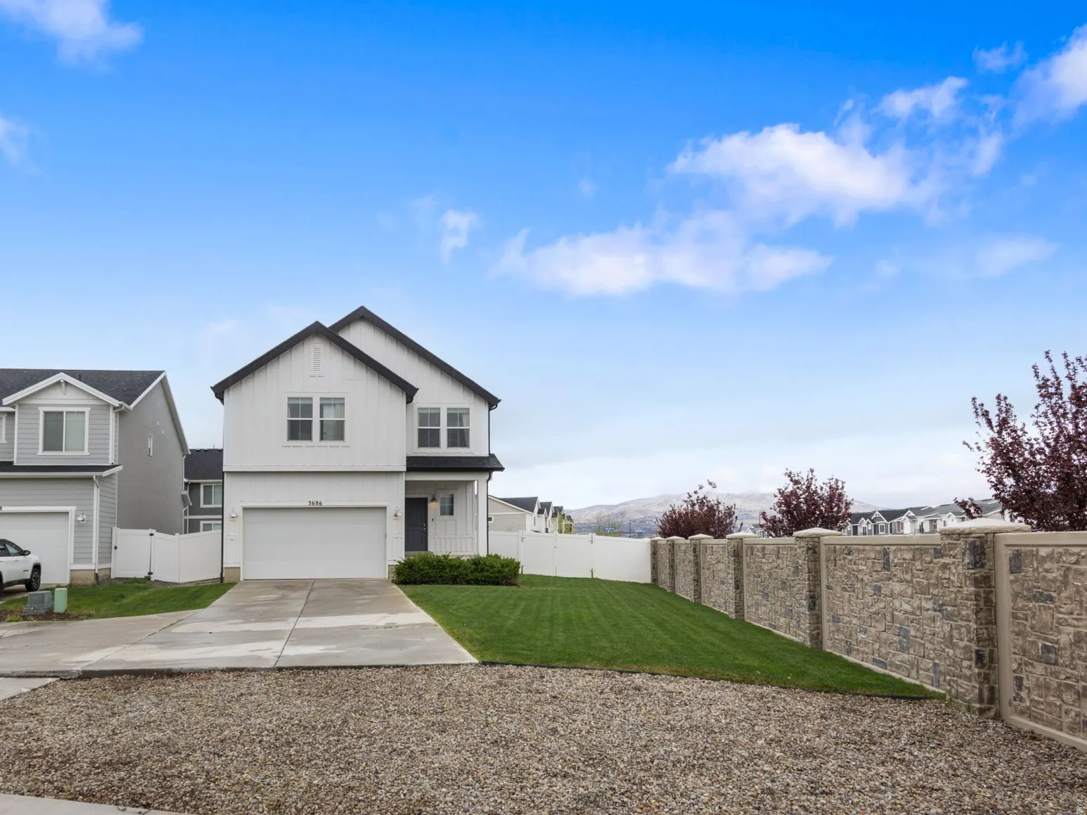 Front exterior featuring large driveway with extra parking