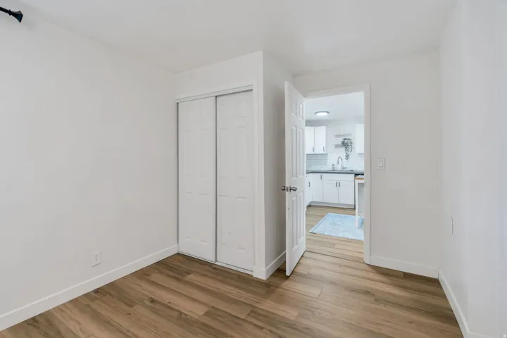 Unfurnished bedroom with light wood-style flooring and a closet