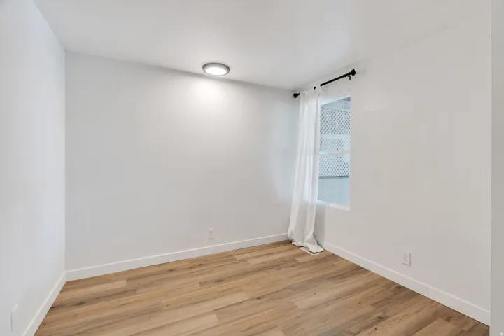 Empty room featuring light wood-style flooring and baseboards