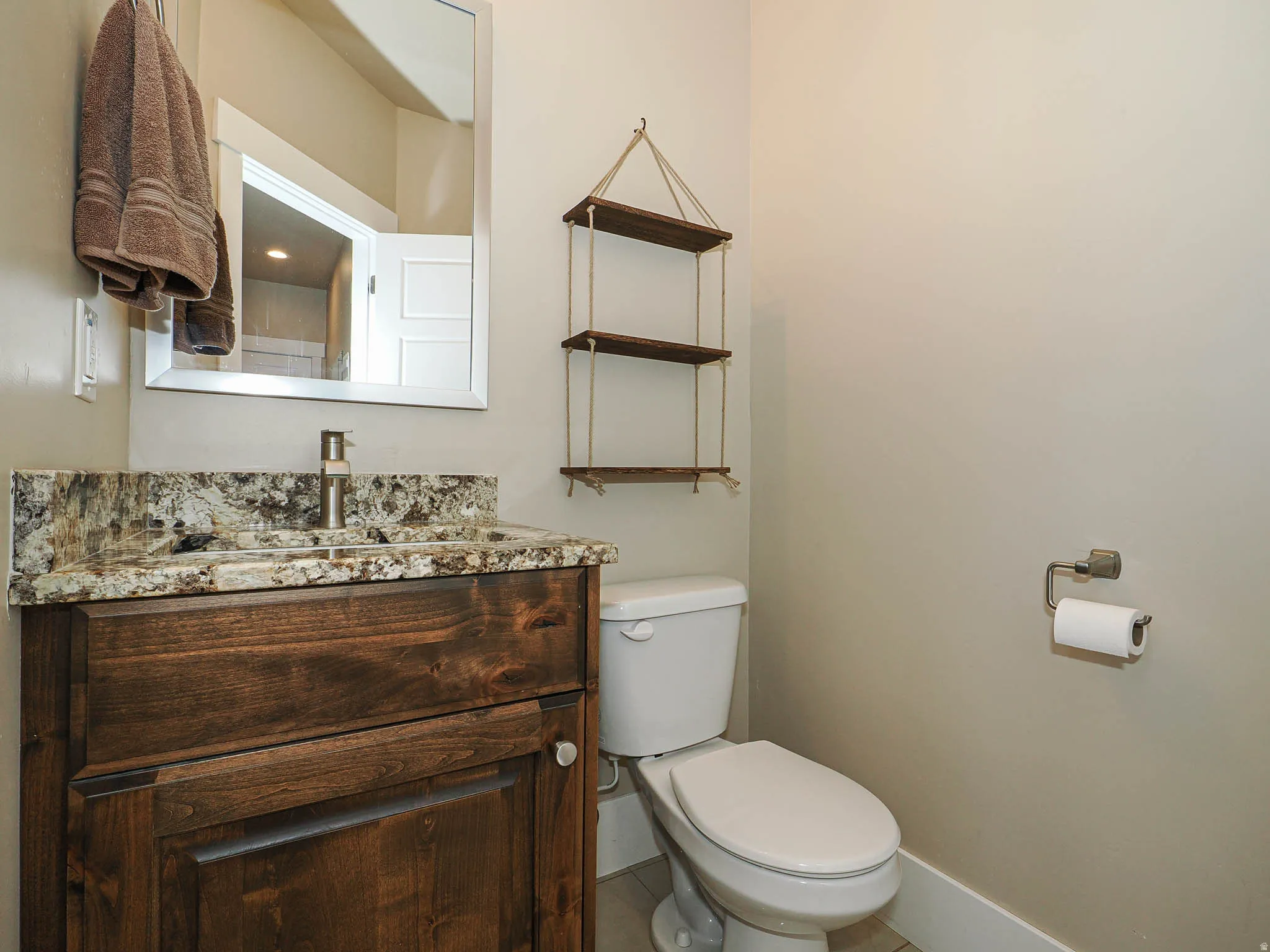 Half bath featuring toilet and vanity