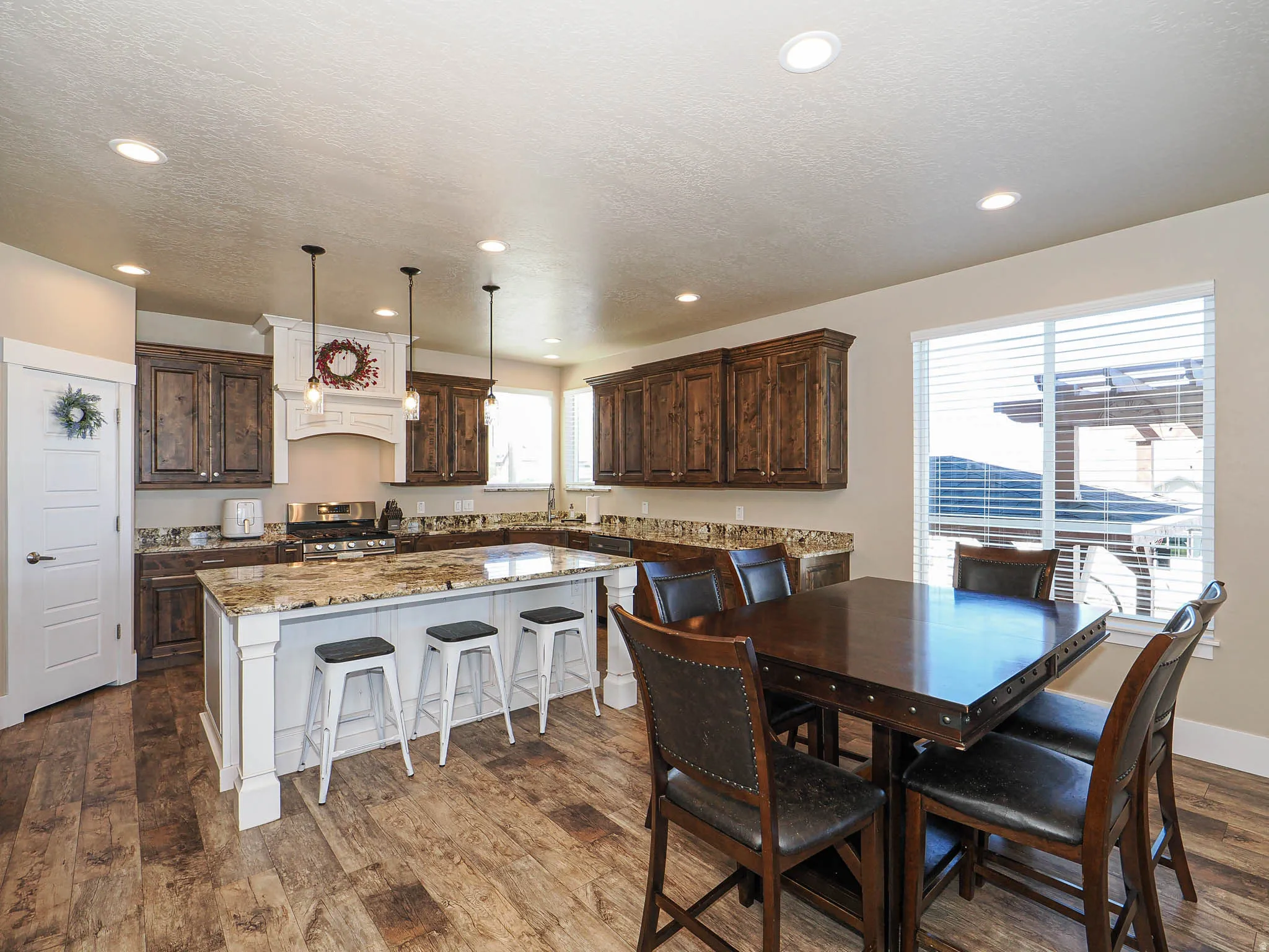 Dining room featuring dark wood-style floors and recessed lighting