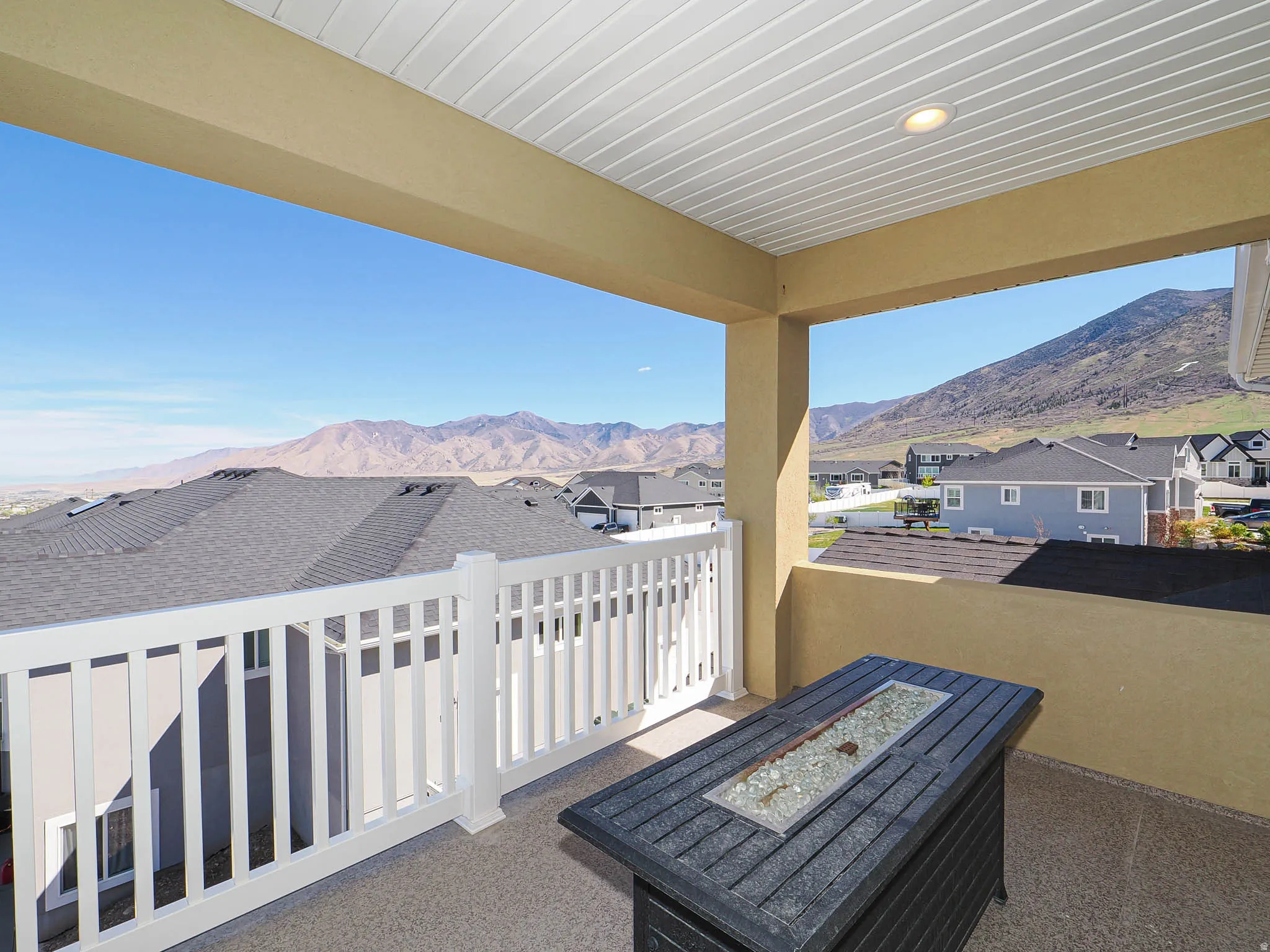 View of patio / terrace with a residential view, a fire pit, and a mountain view