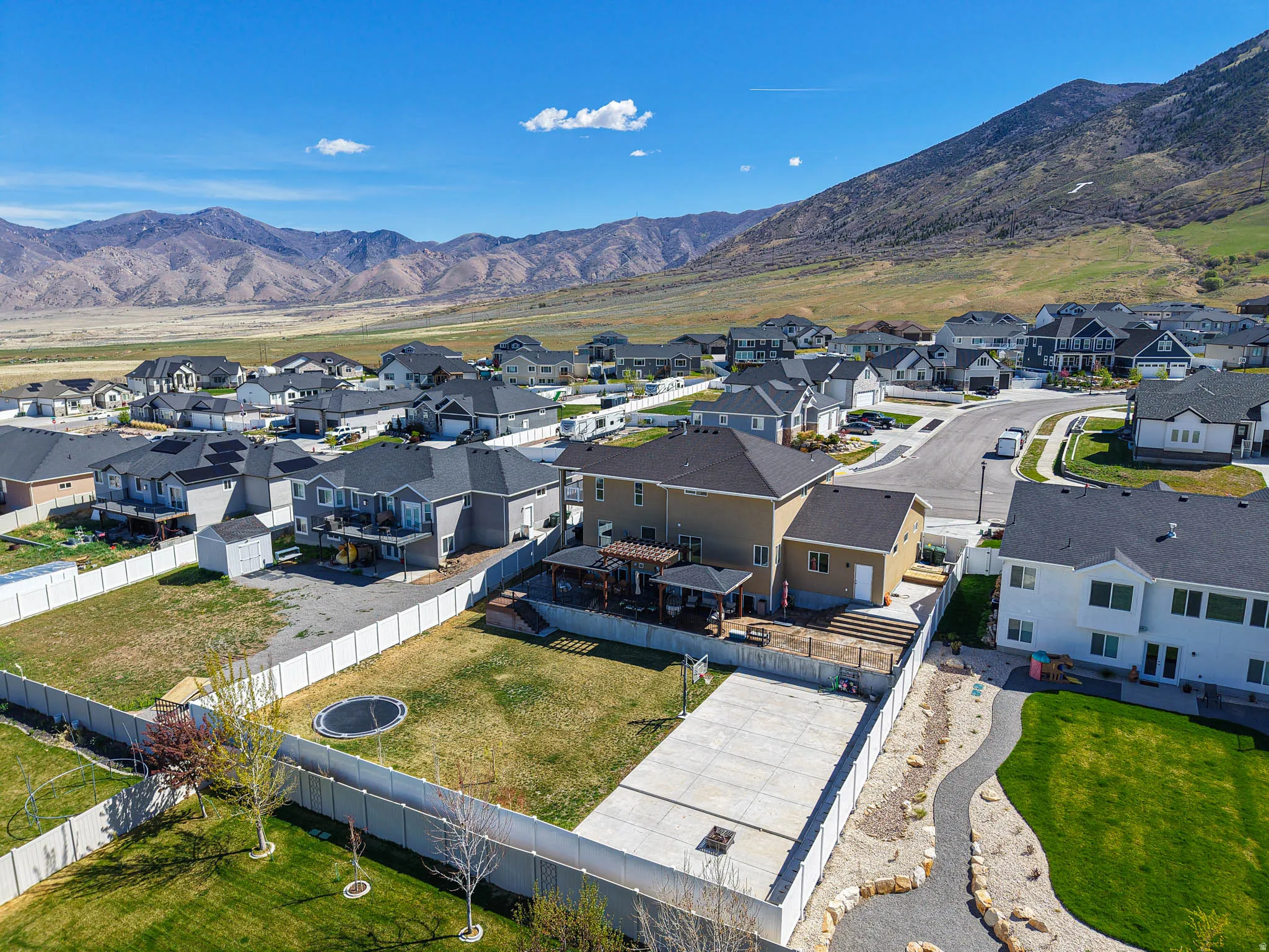 Aerial perspective of suburban area featuring a mountain backdrop