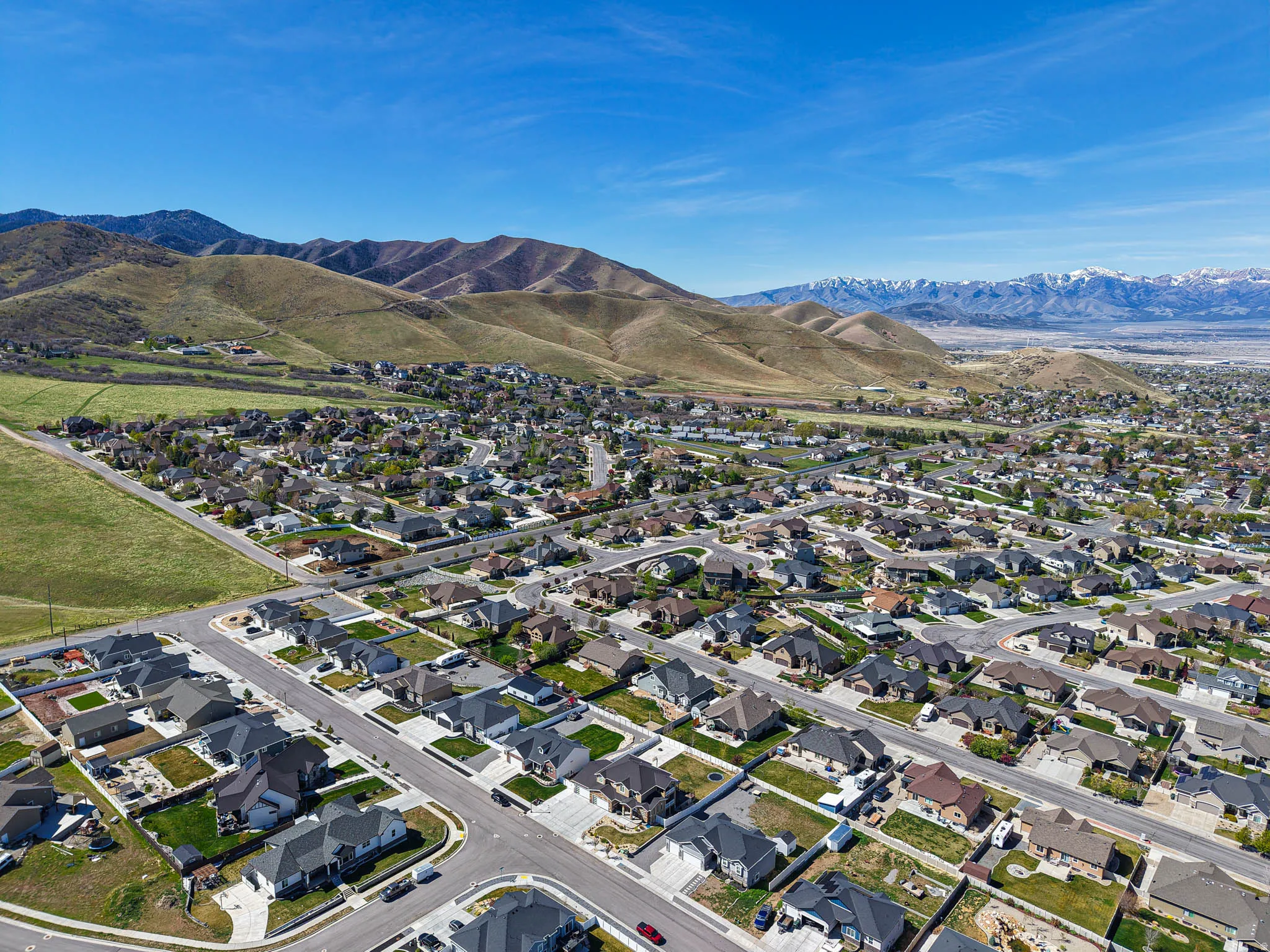 Aerial perspective of suburban area with a mountainous background
