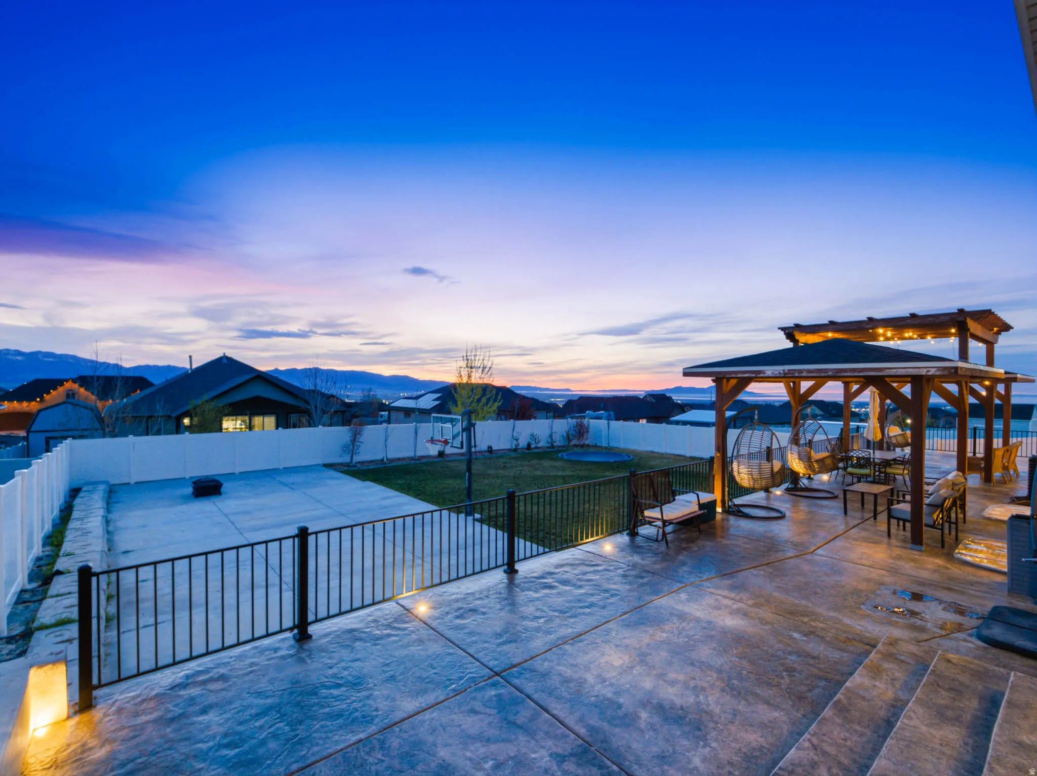 View of community with a mountain view, a fenced backyard, a patio area, and a gazebo