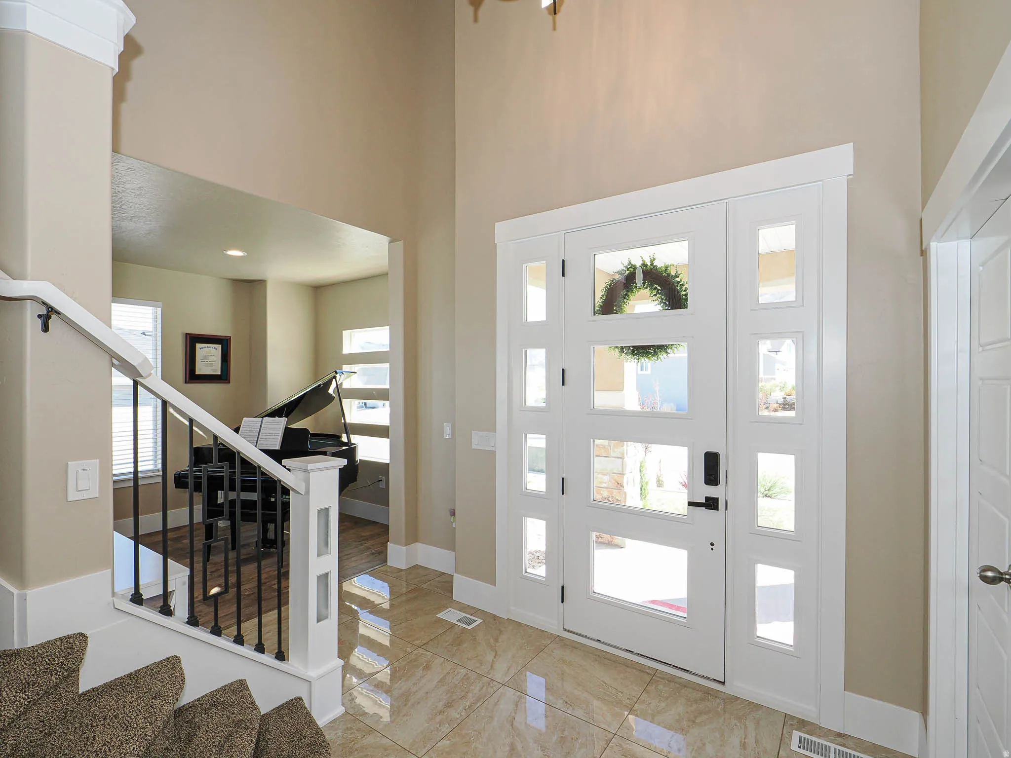 Entryway with stairway and a high ceiling