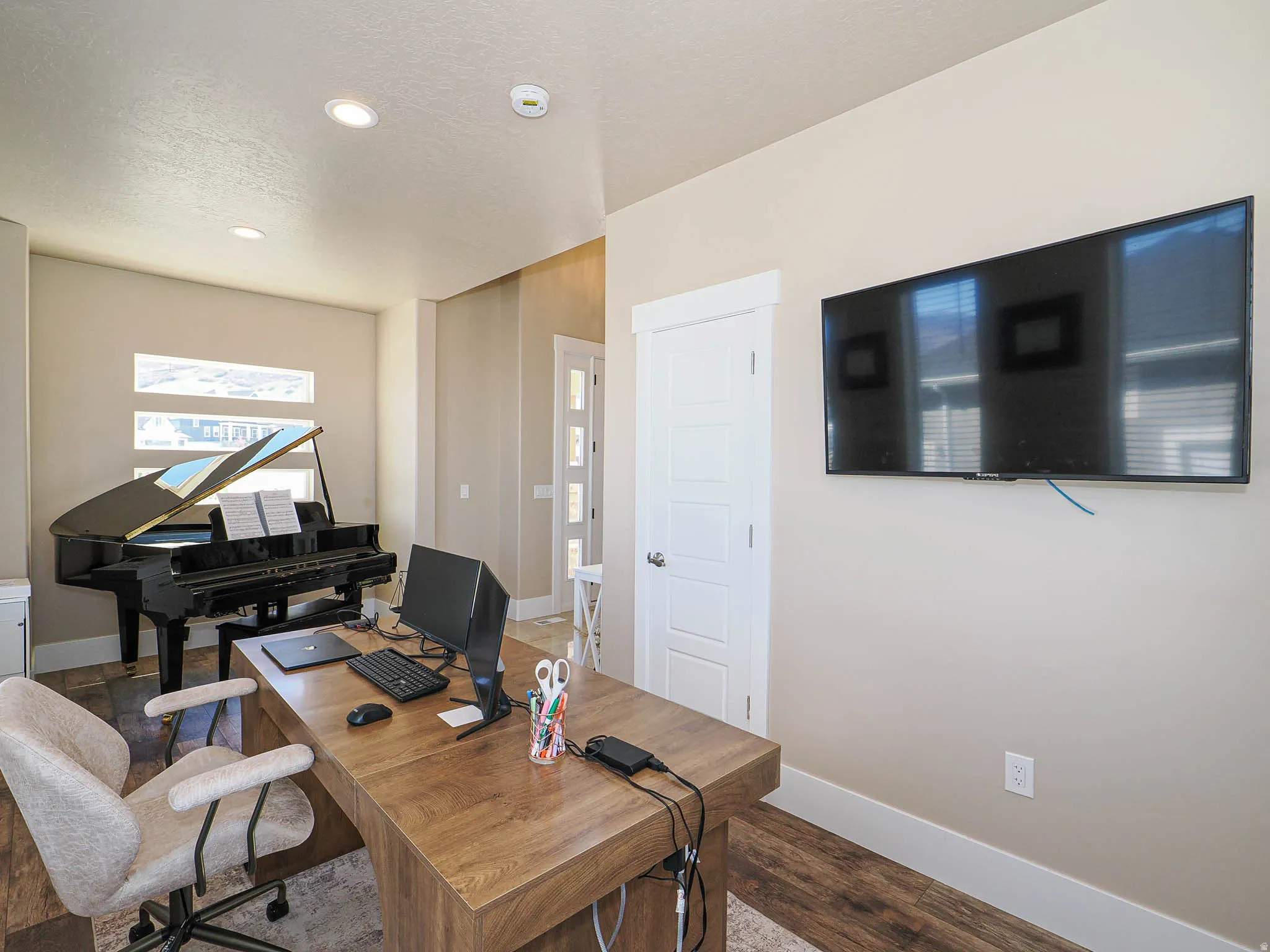 Office area featuring wood finished floors, a textured ceiling, and recessed lighting