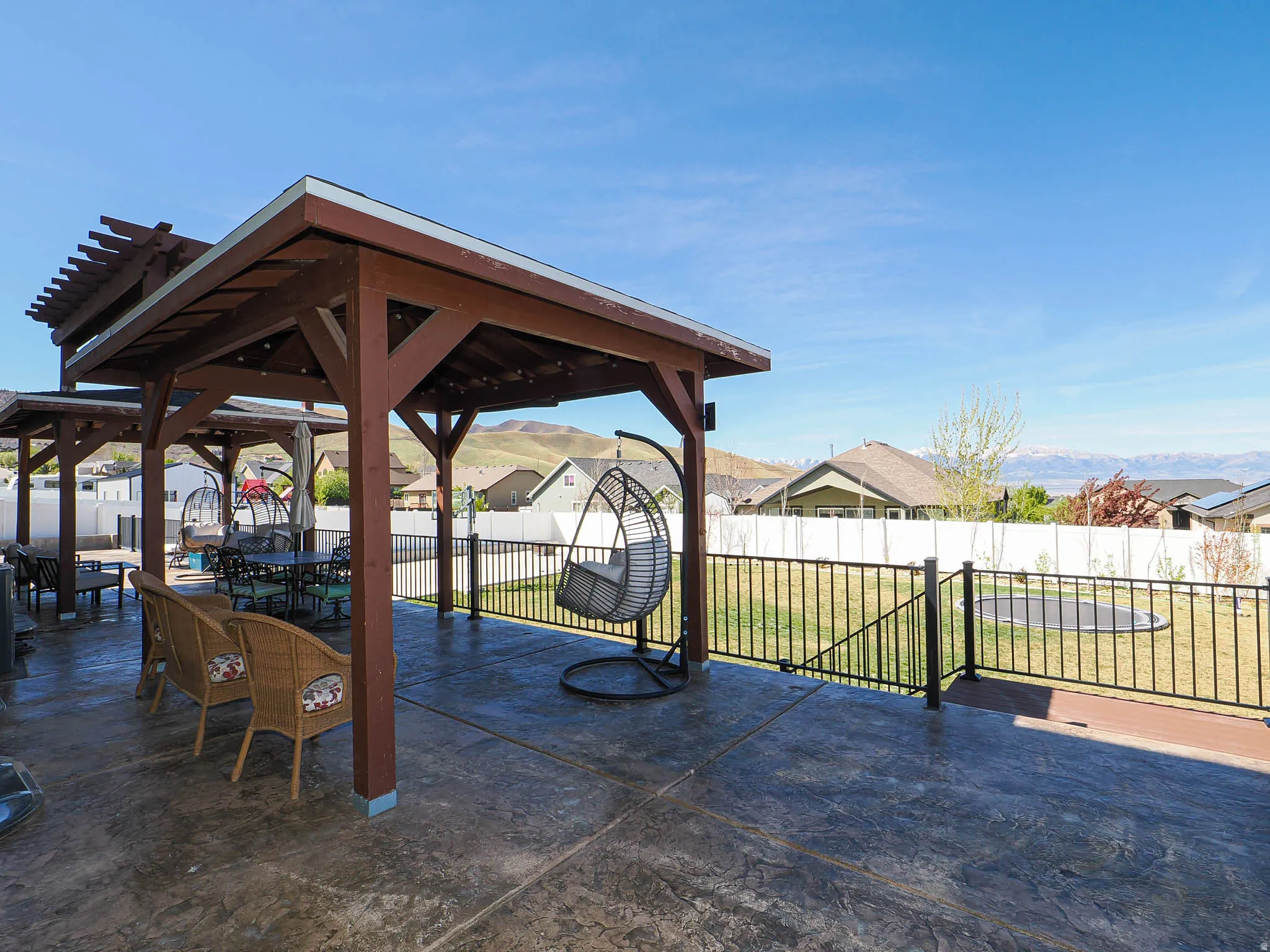Fenced backyard featuring outdoor dining space, a patio, and a residential view