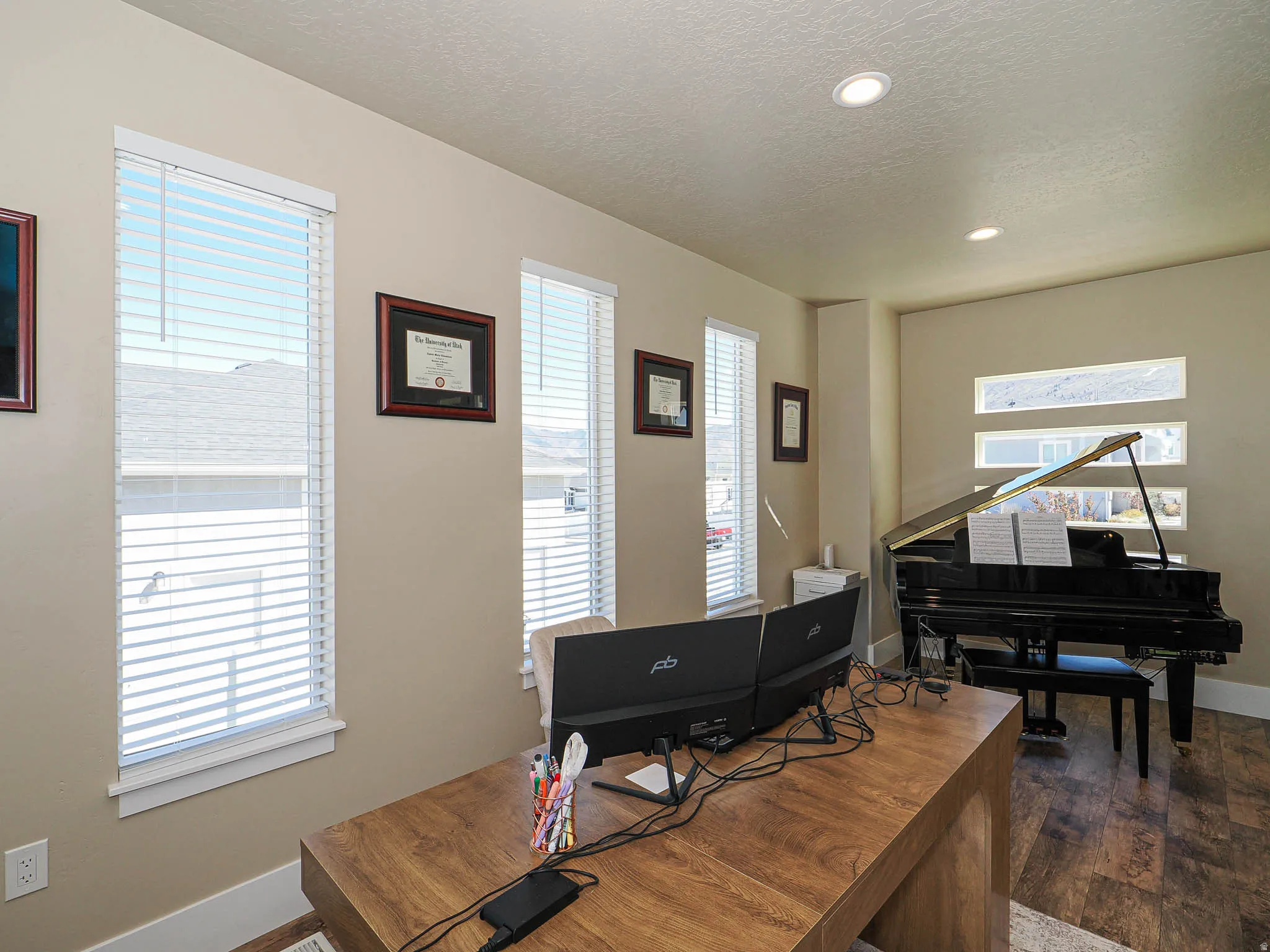 Home office featuring recessed lighting, dark wood-style floors, and a textured ceiling