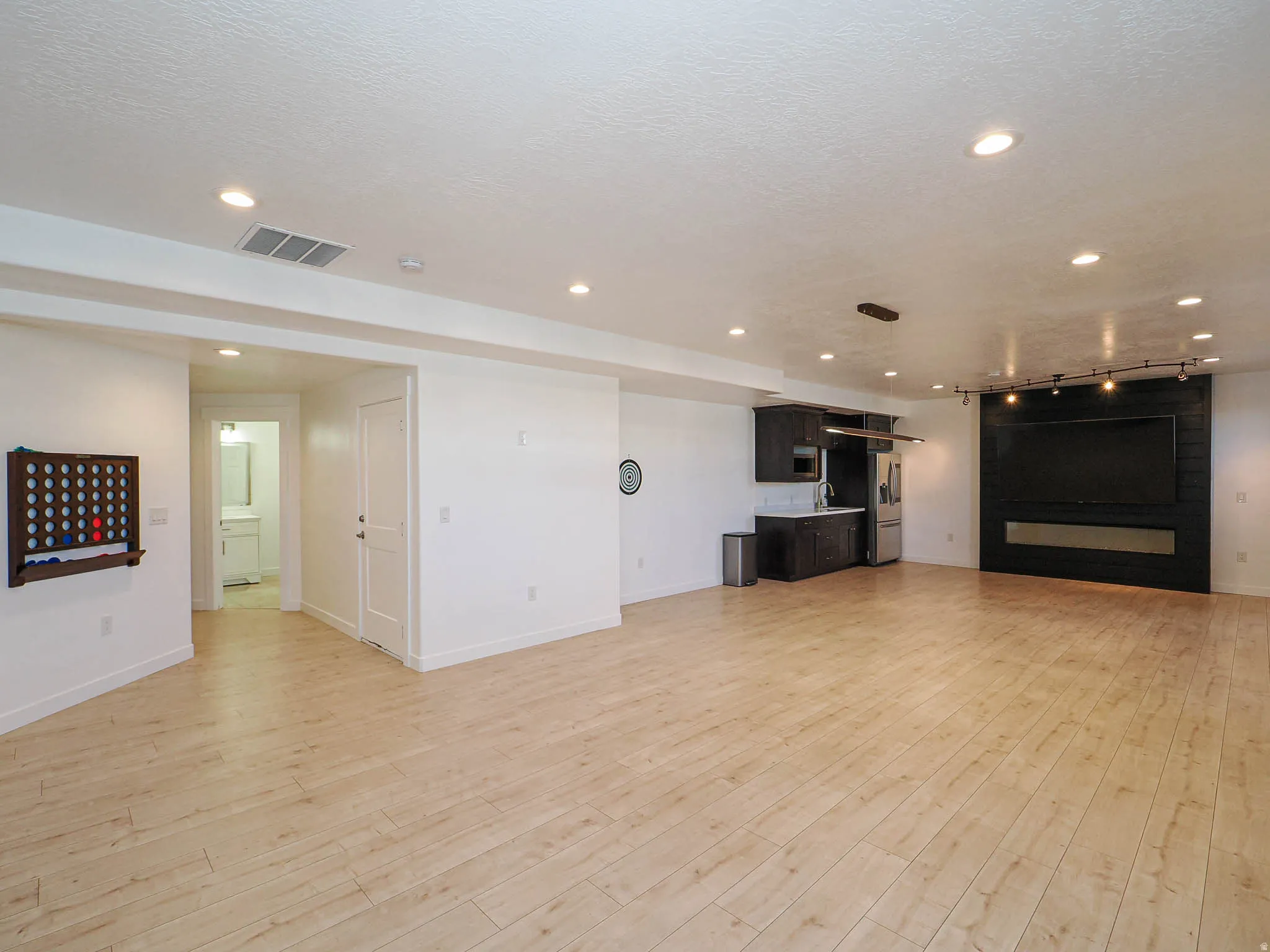 Unfurnished living room with light wood-type flooring and recessed lighting