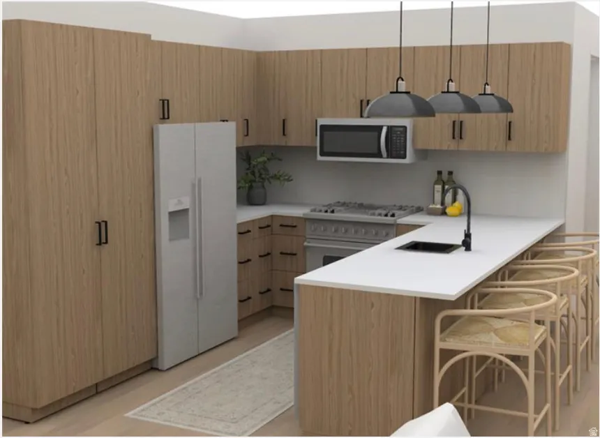 Kitchen with white refrigerator with ice dispenser, light countertops, a peninsula, stainless steel microwave, and a kitchen breakfast bar