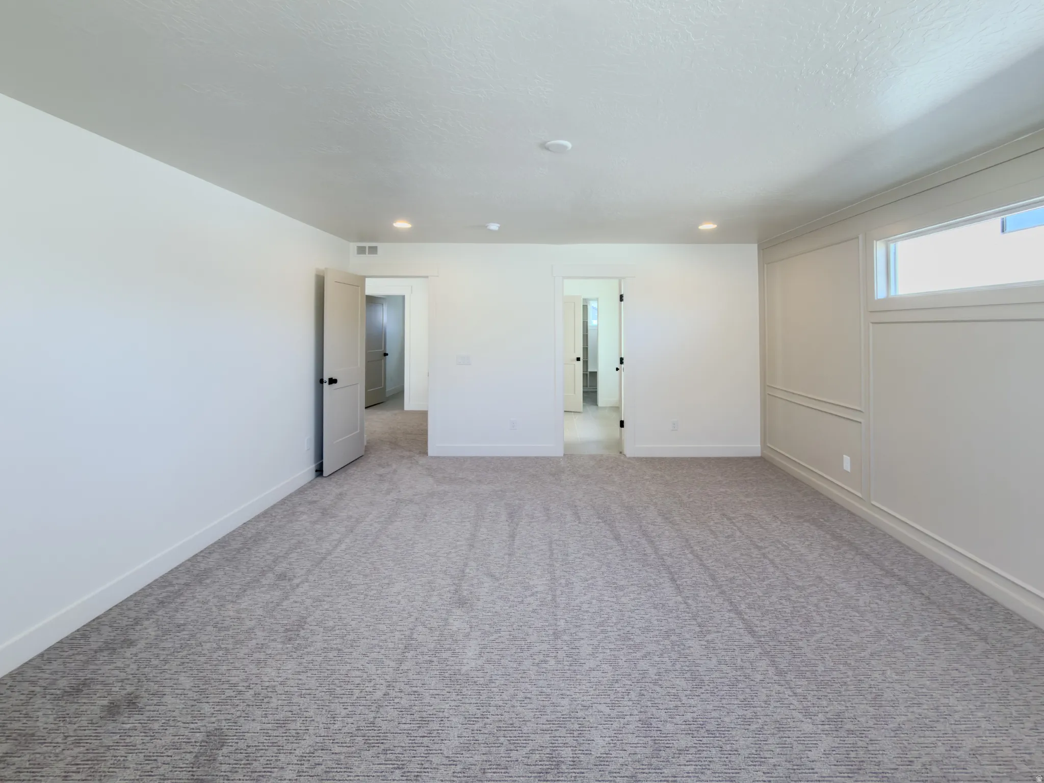 Unfurnished bedroom with carpet floors and recessed lighting