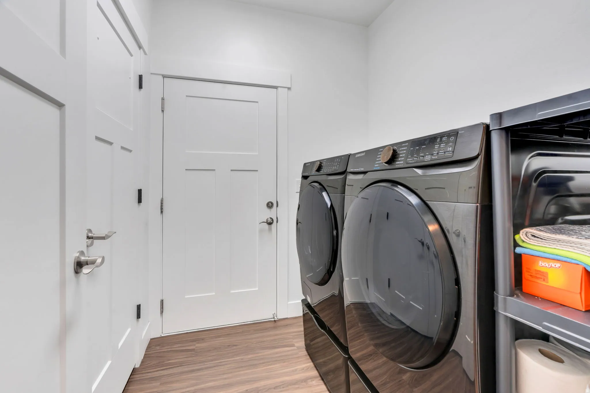 Laundry room with light wood-type flooring and washing machine and clothes dryer; Washer and Dryer included. d