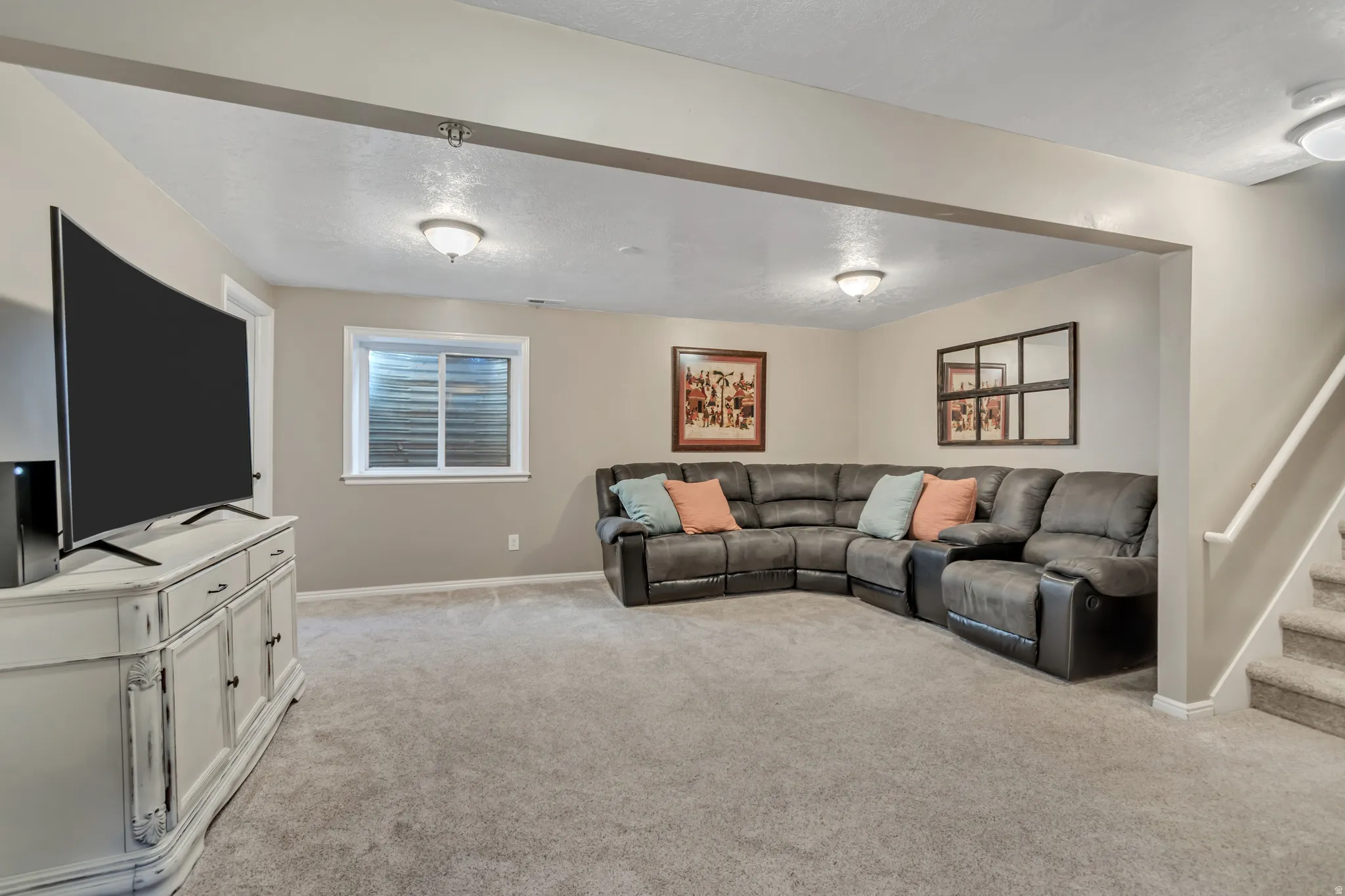 Living area with light carpet and stairs
