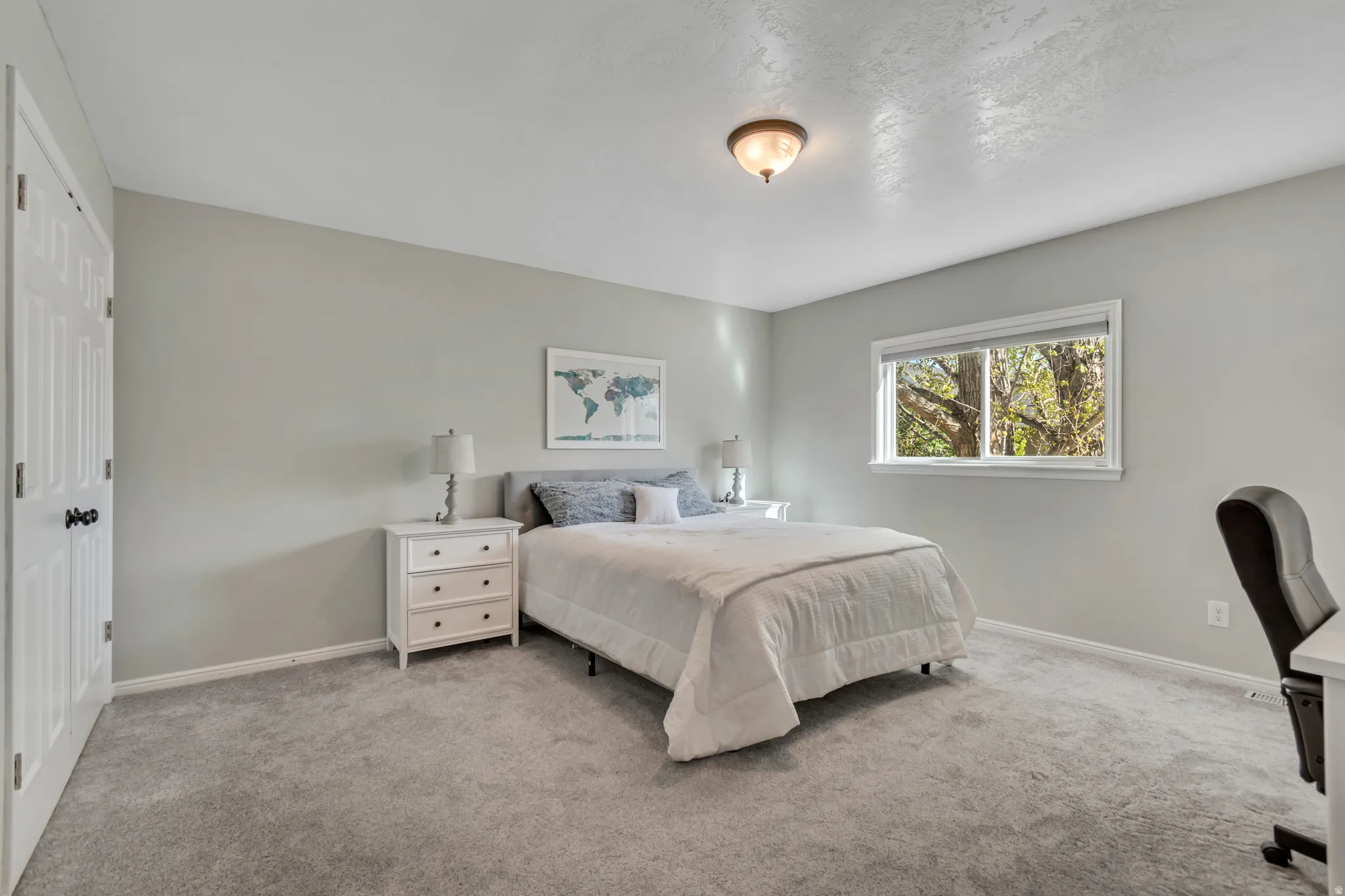 Carpeted bedroom with baseboards and a closet