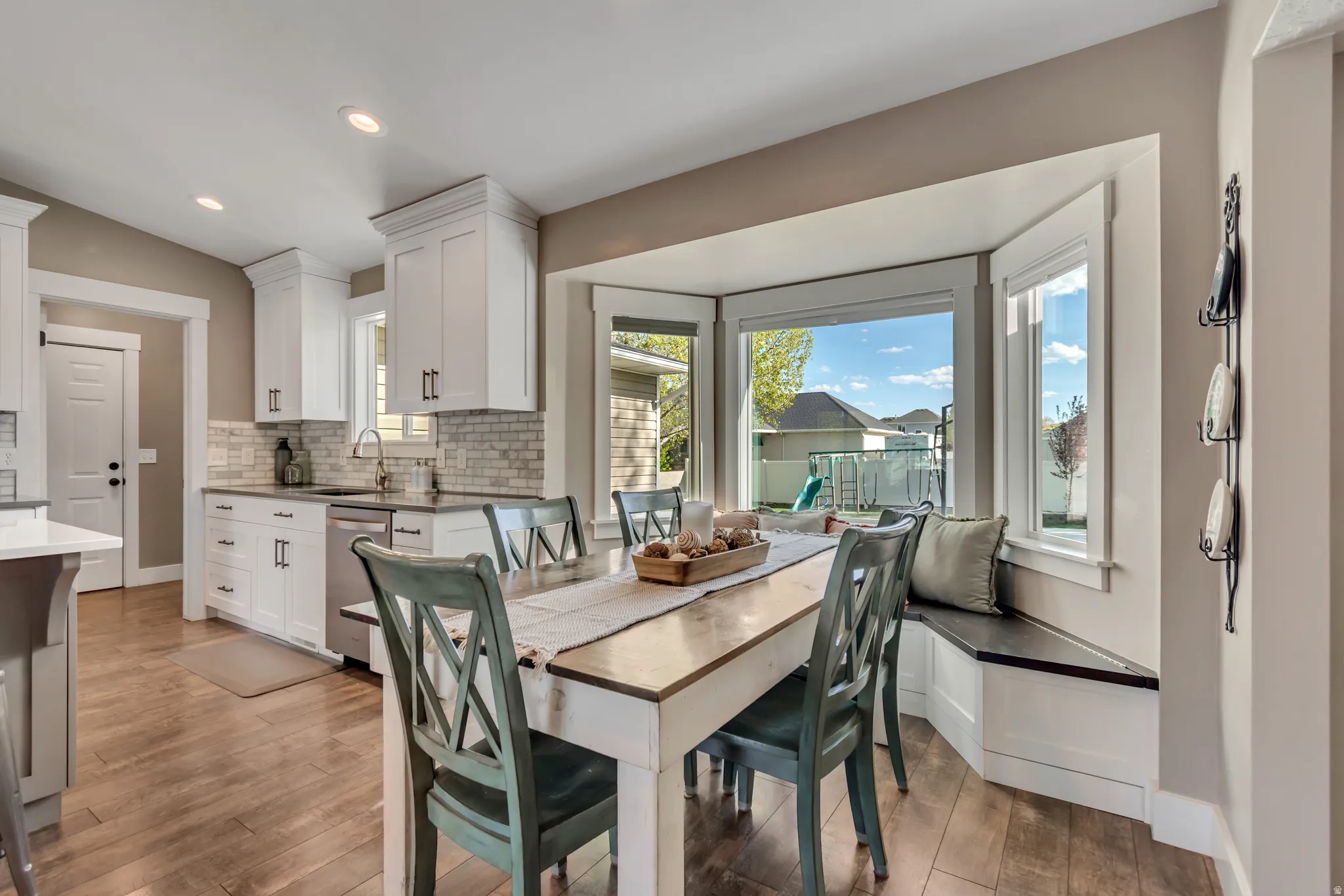 Dining space featuring light wood-style flooring, lofted ceiling, and recessed lighting