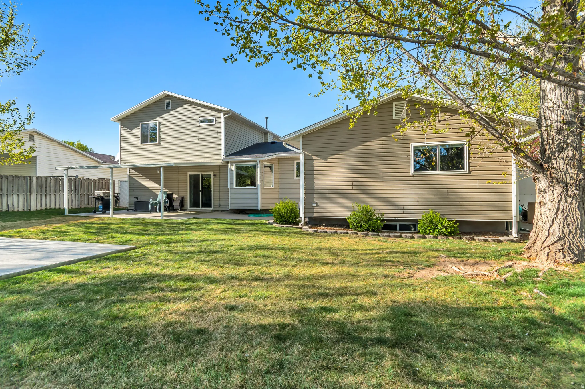 Back of house featuring a patio area and a yard