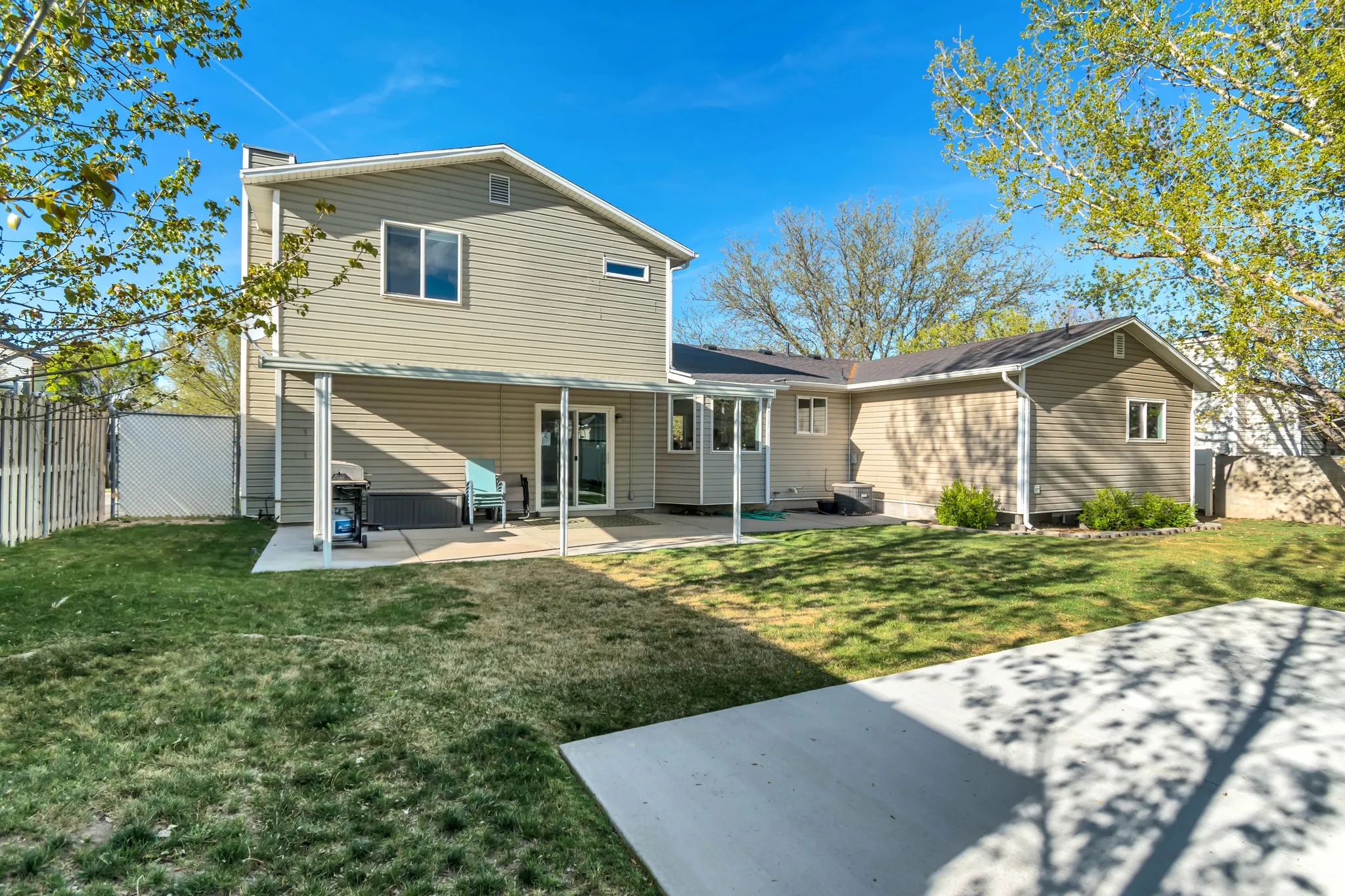 Back of house featuring a patio and a lawn
