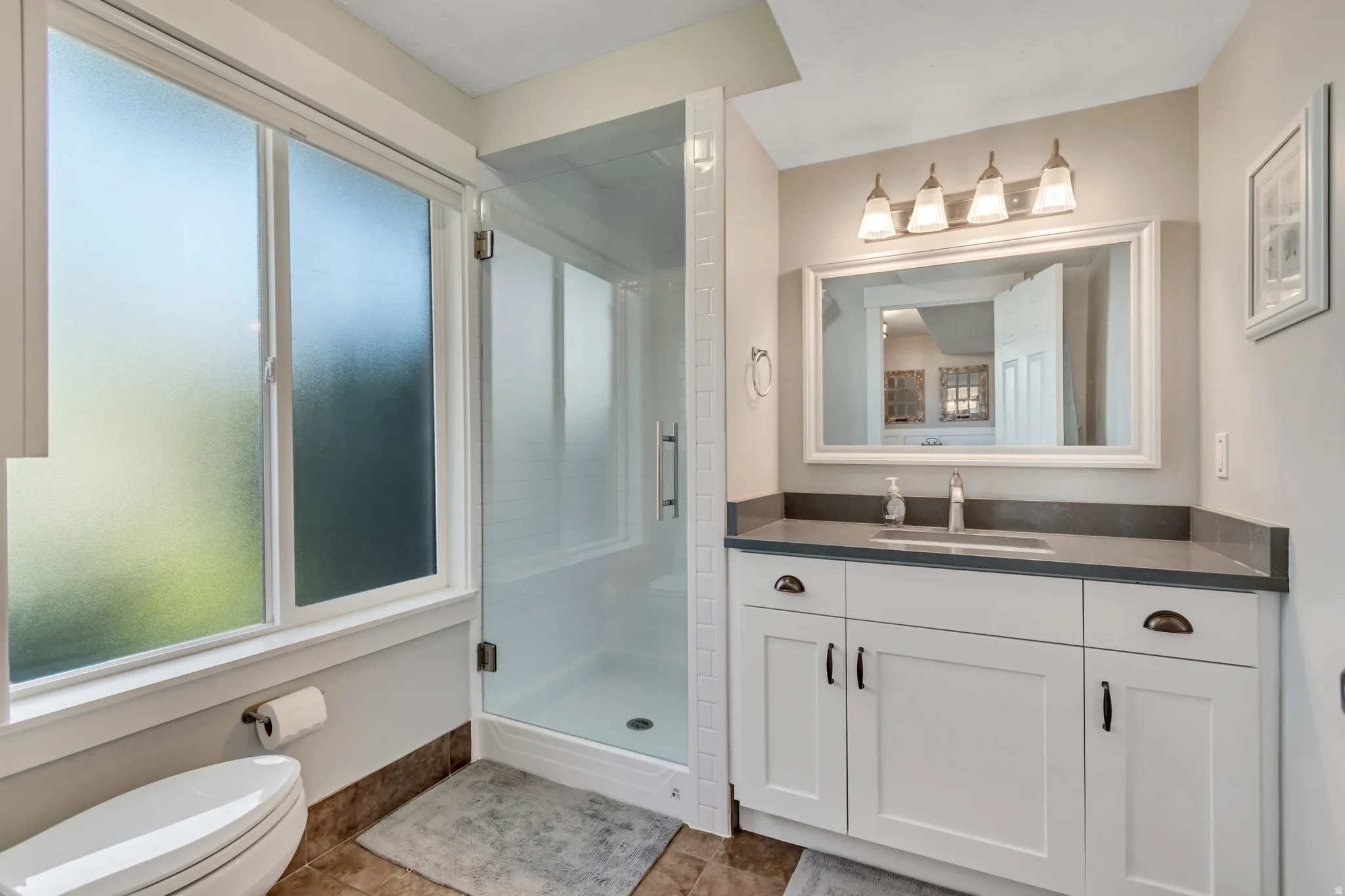 Bathroom with vanity and a stall shower