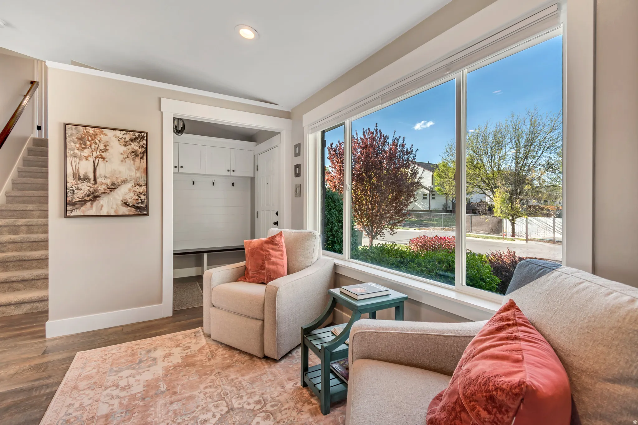 Living area with wood finished floors and recessed lighting