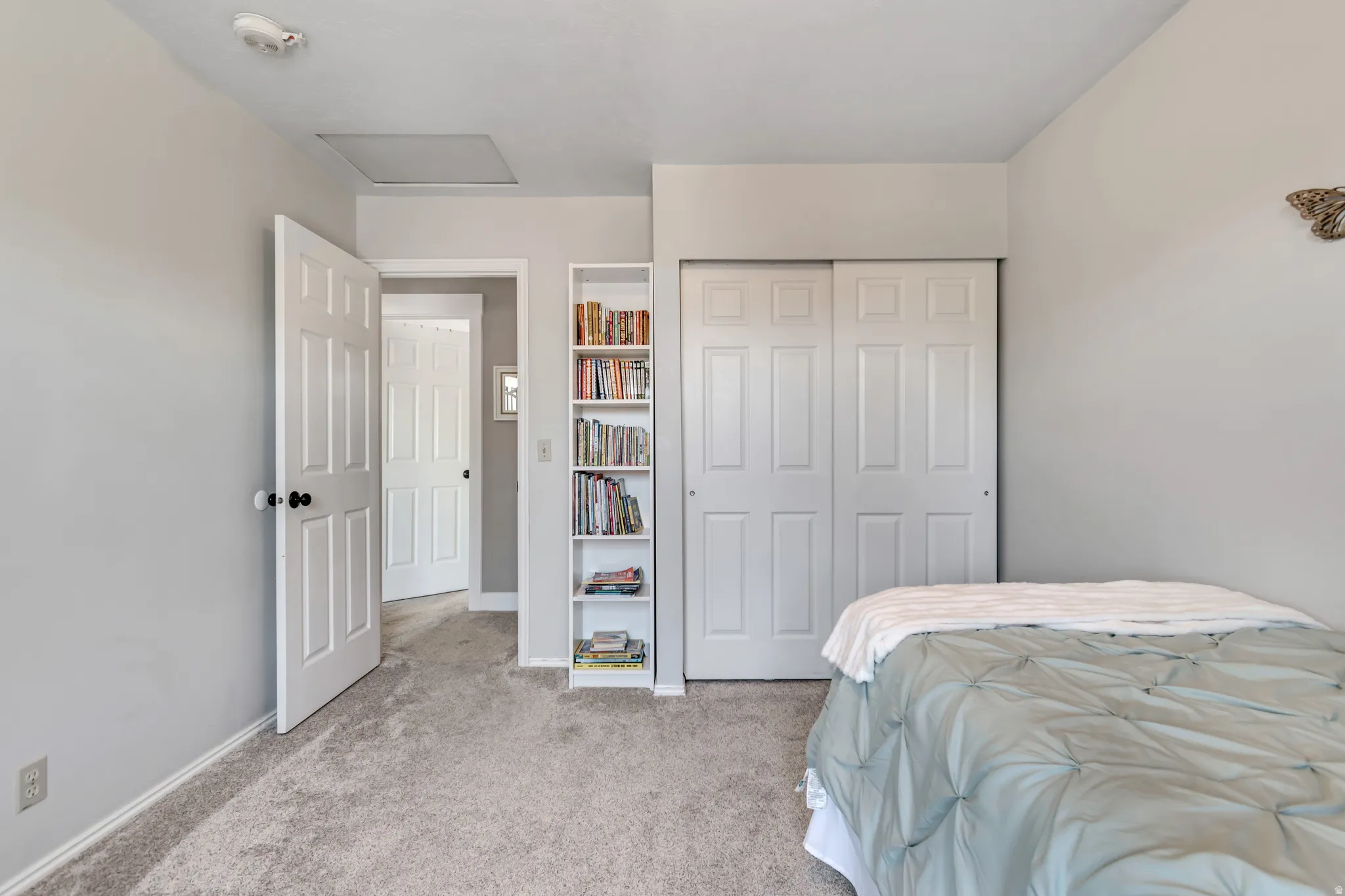 Bedroom featuring carpet flooring and a closet