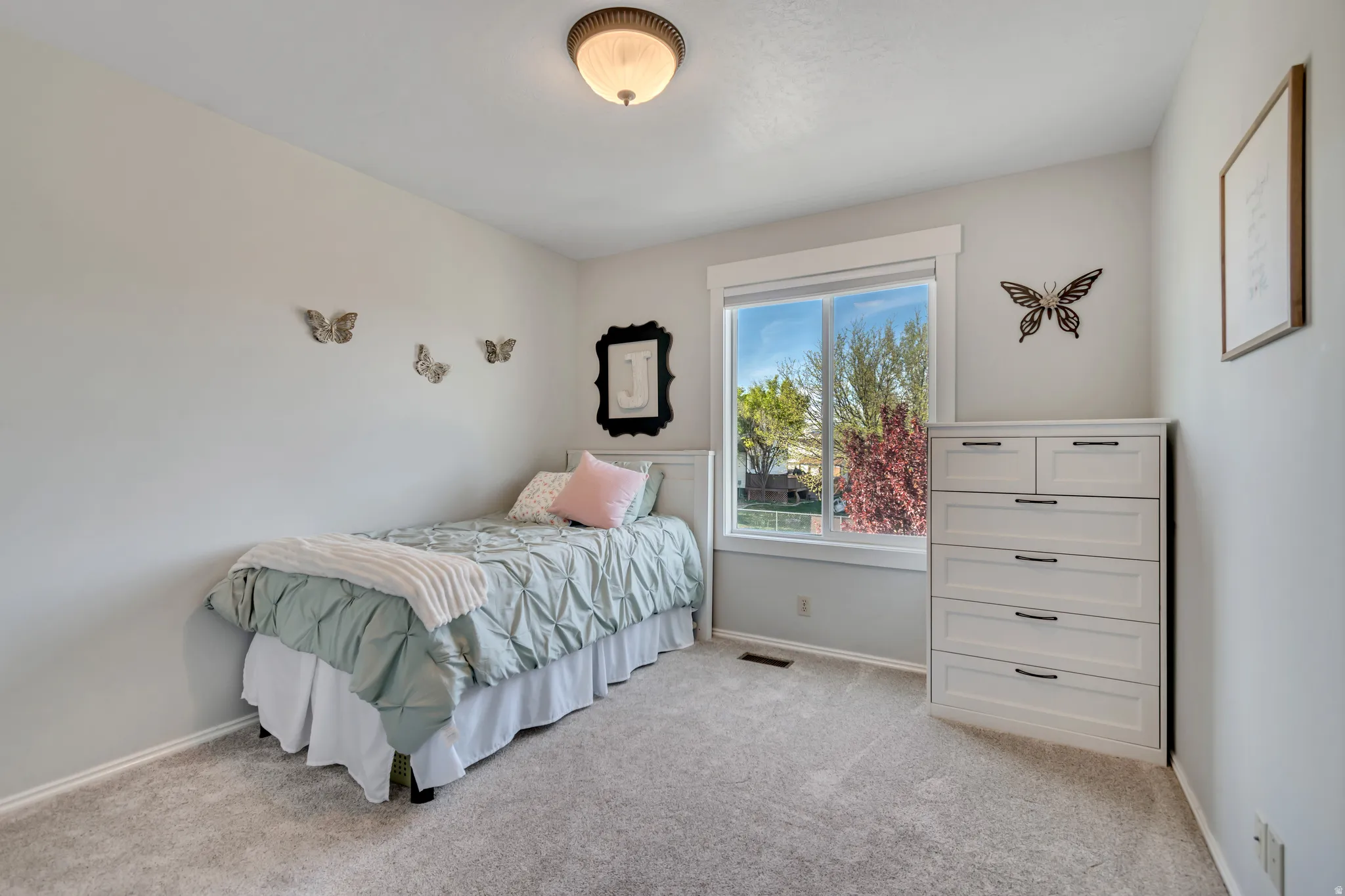 Bedroom featuring baseboards and light carpet