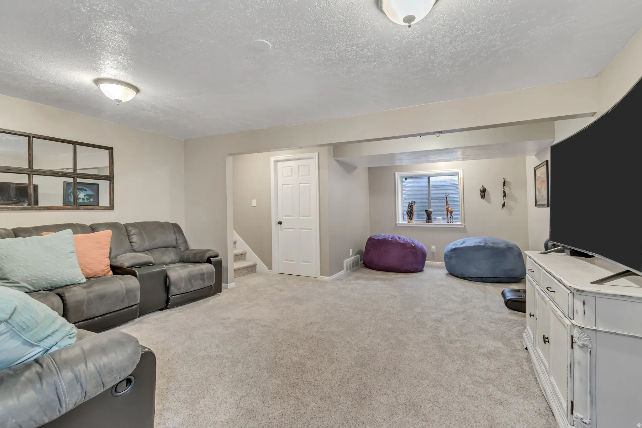 Living room with light carpet and a textured ceiling