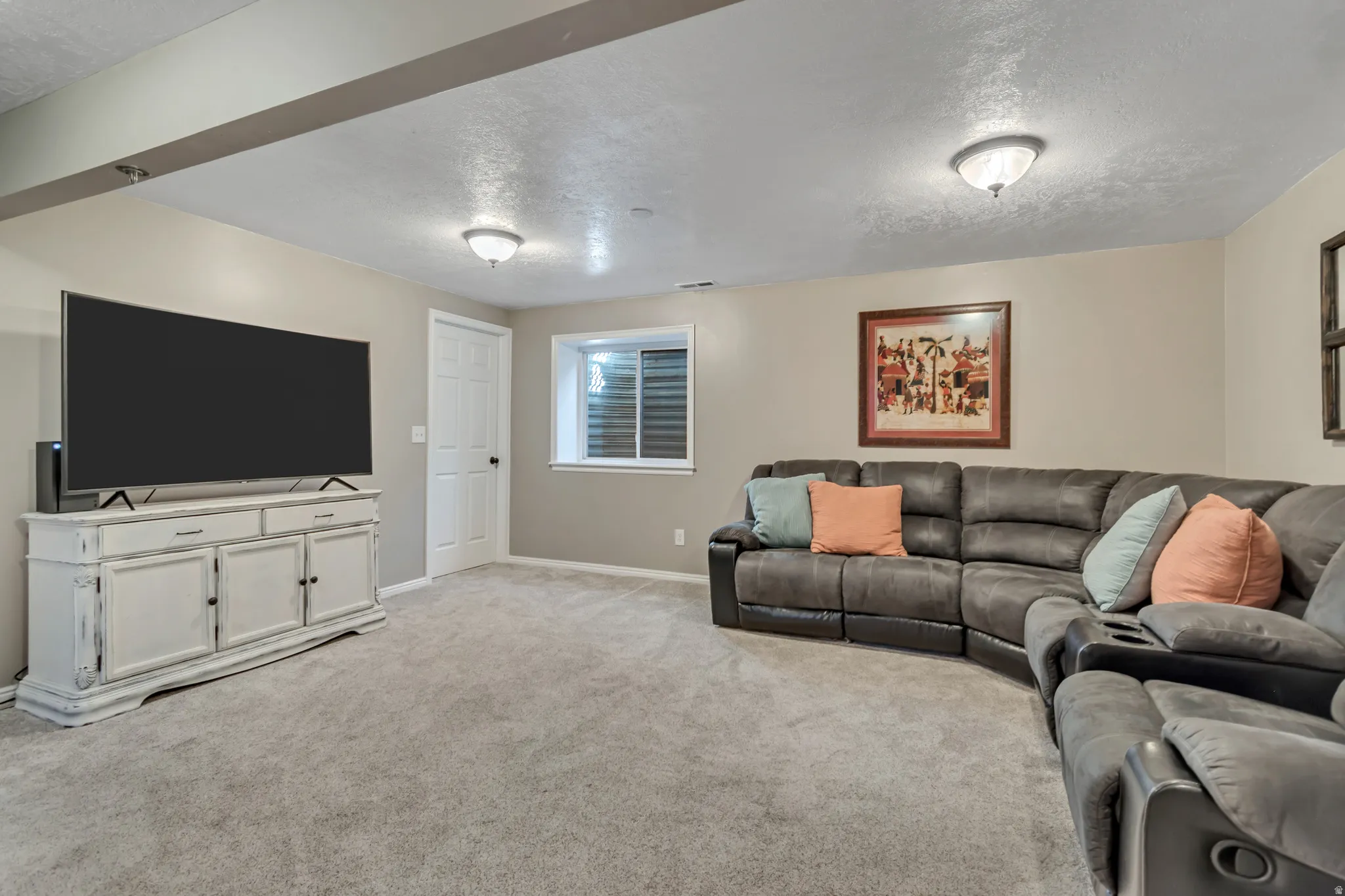Living room featuring a textured ceiling and light colored carpet