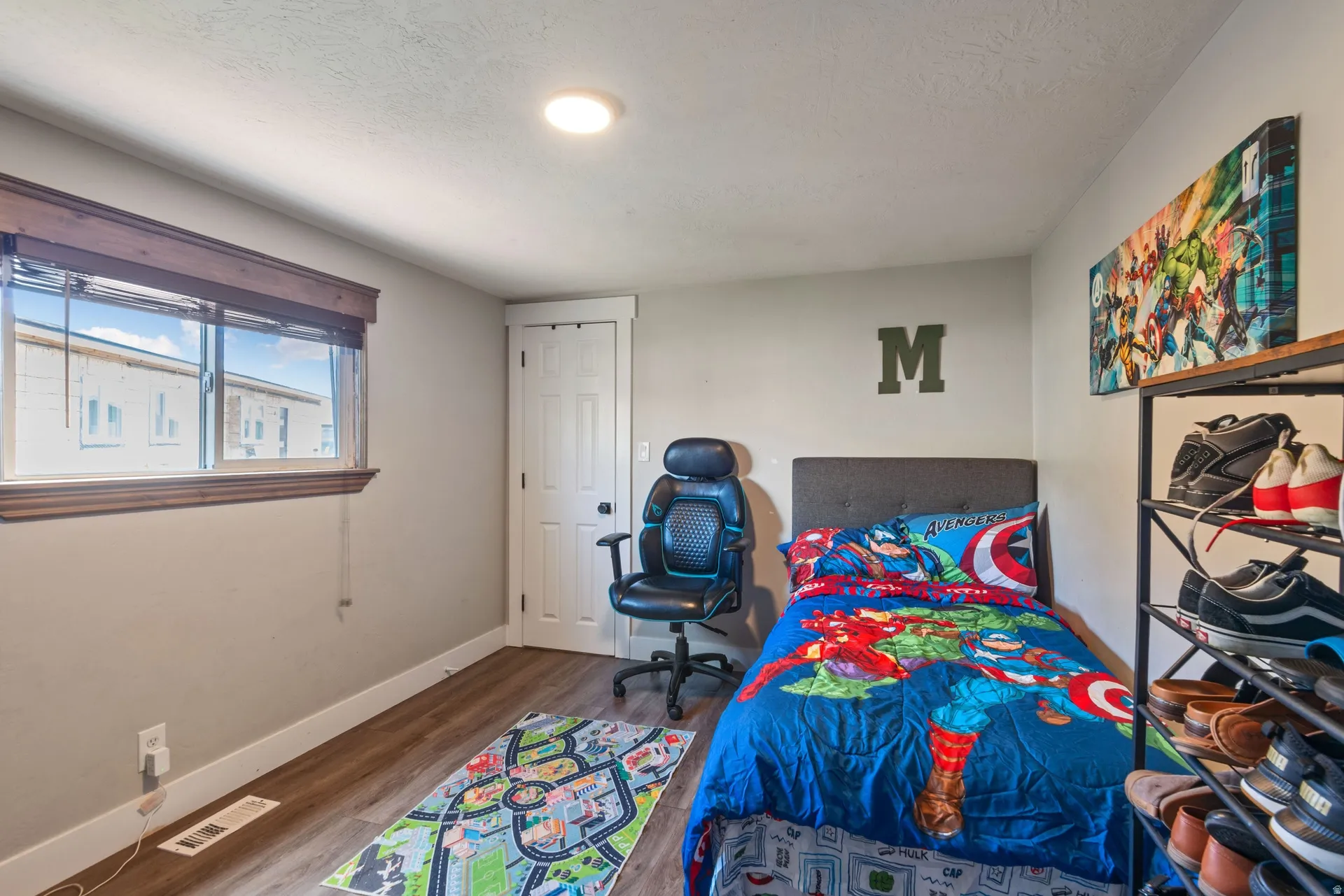 Bedroom featuring dark wood-style flooring and a textured ceiling