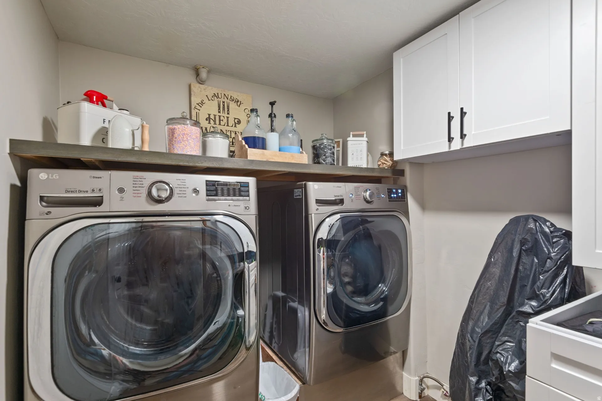 Laundry area with cabinet space and independent washer and dryer