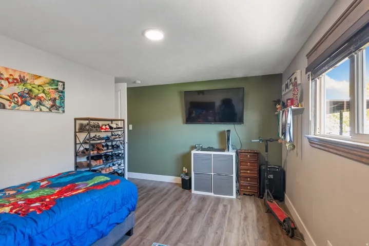 Bedroom with wood finished floors and baseboards