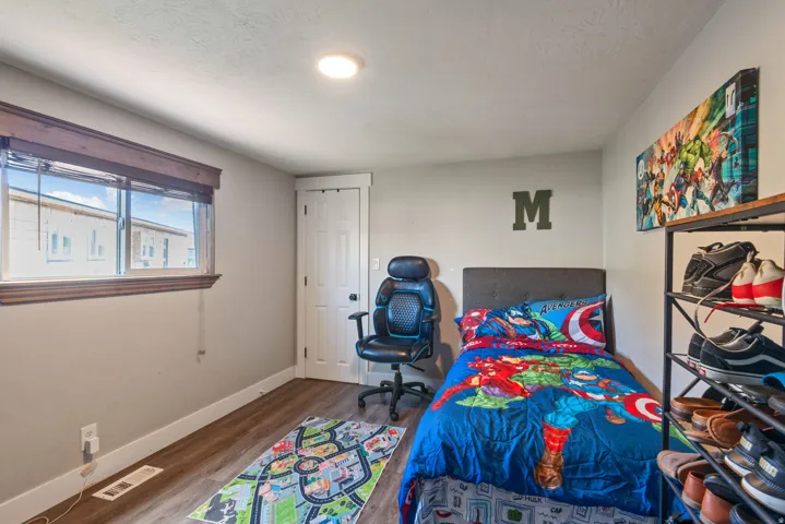 Bedroom featuring dark wood-style flooring and a textured ceiling