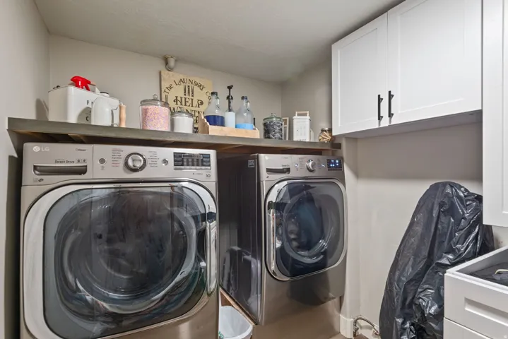 Laundry area with cabinet space and independent washer and dryer