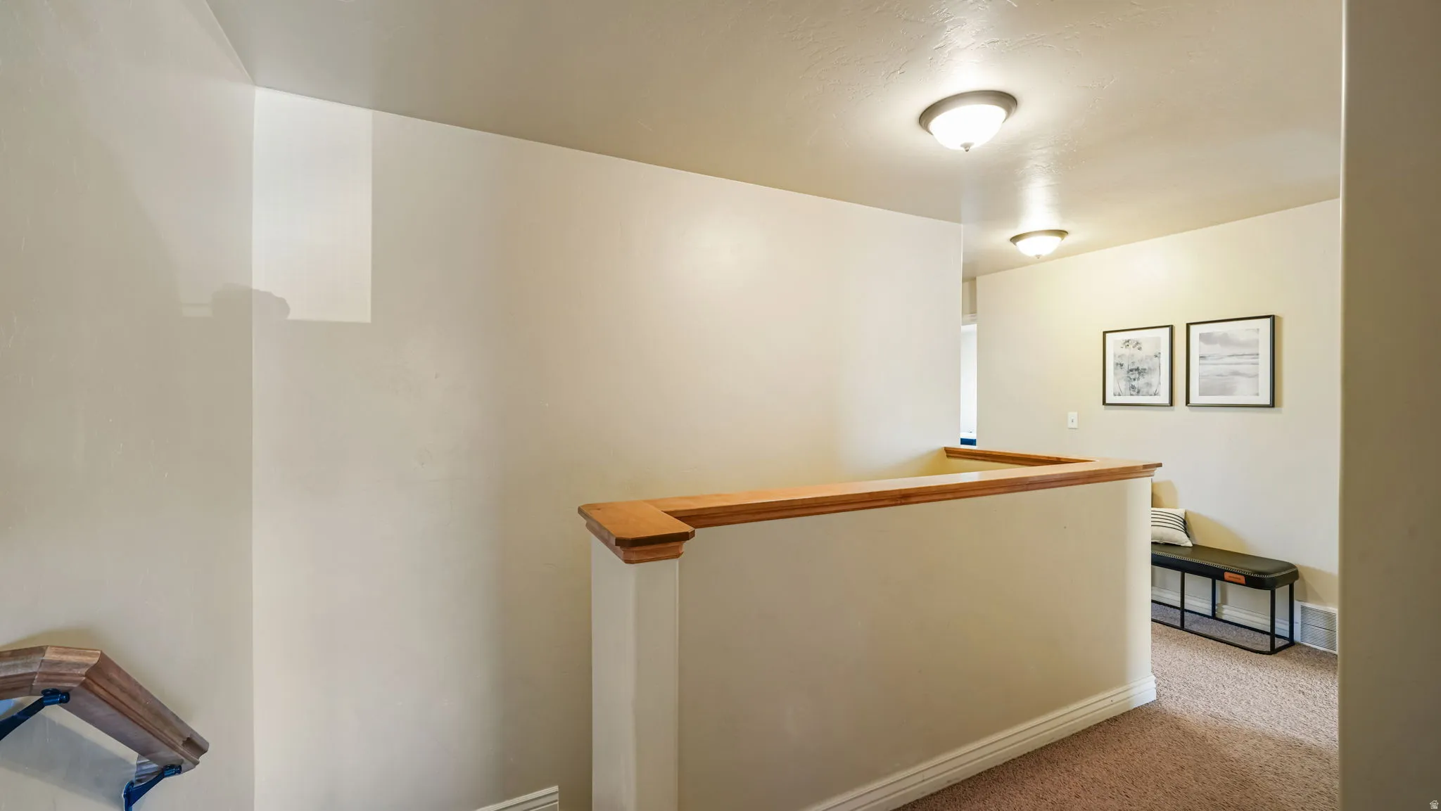 Hallway featuring an upstairs landing and carpet flooring