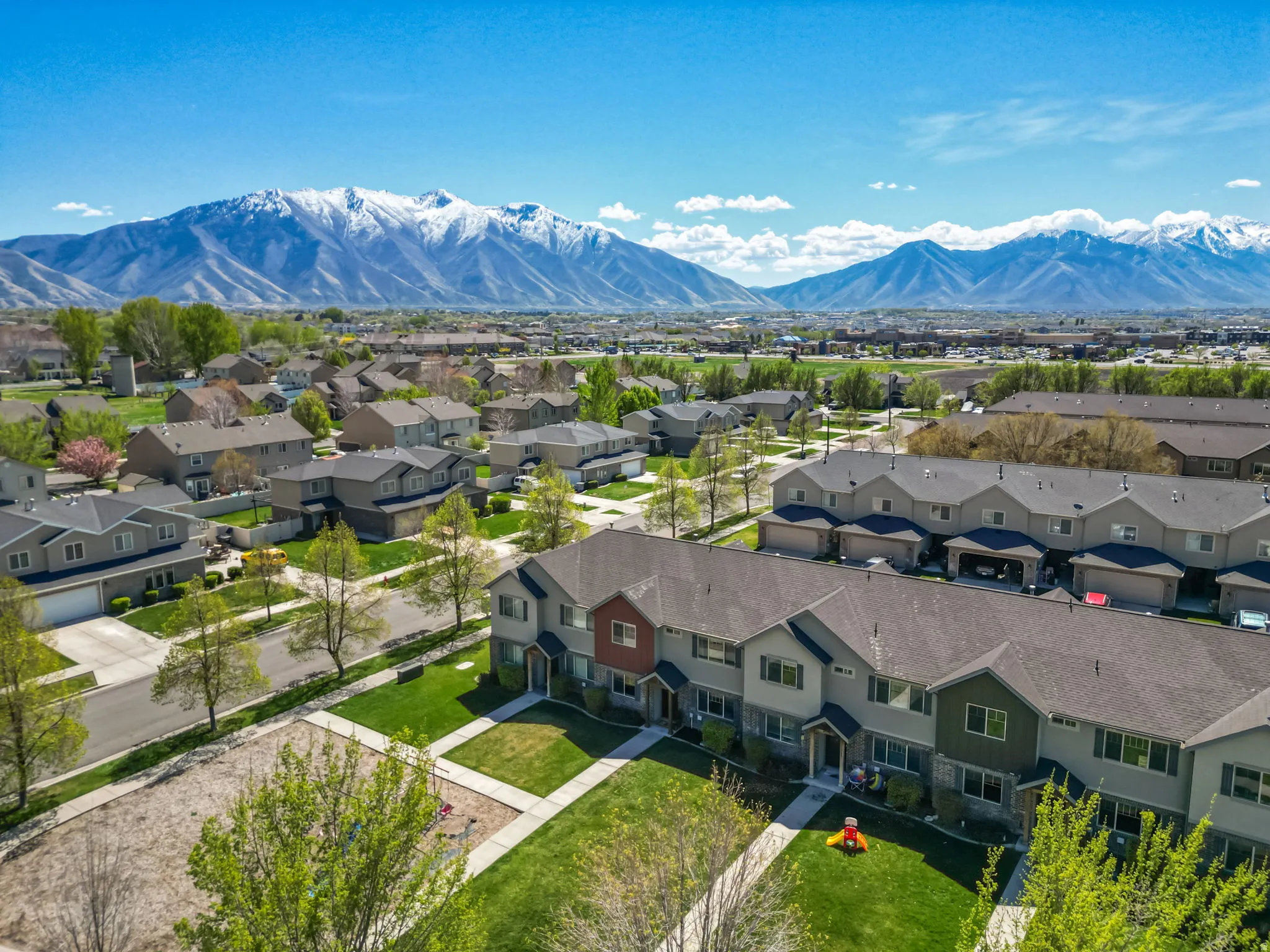 Aerial view of residential area featuring a mountain backdrop