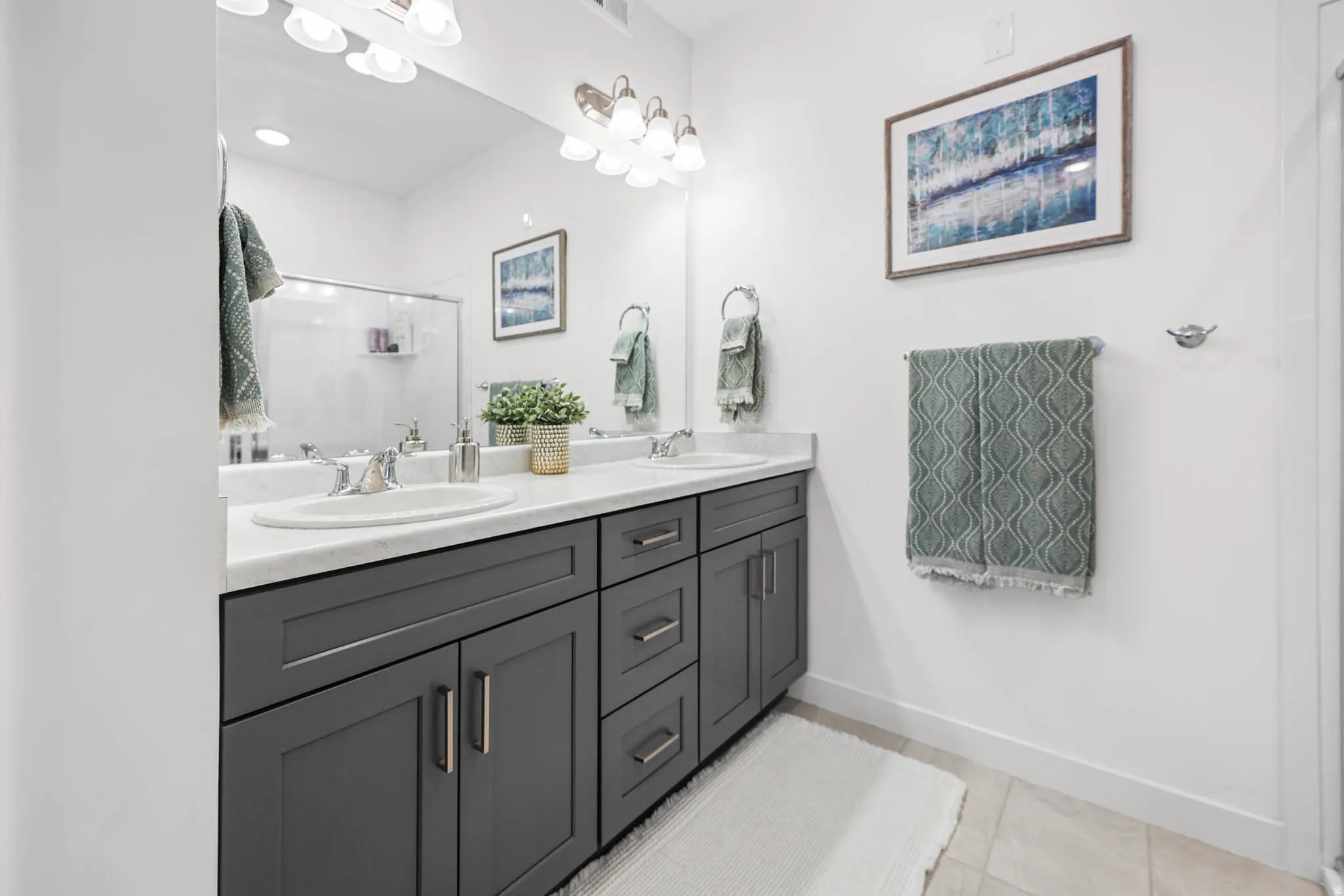 Full primary bathroom featuring a double vanity