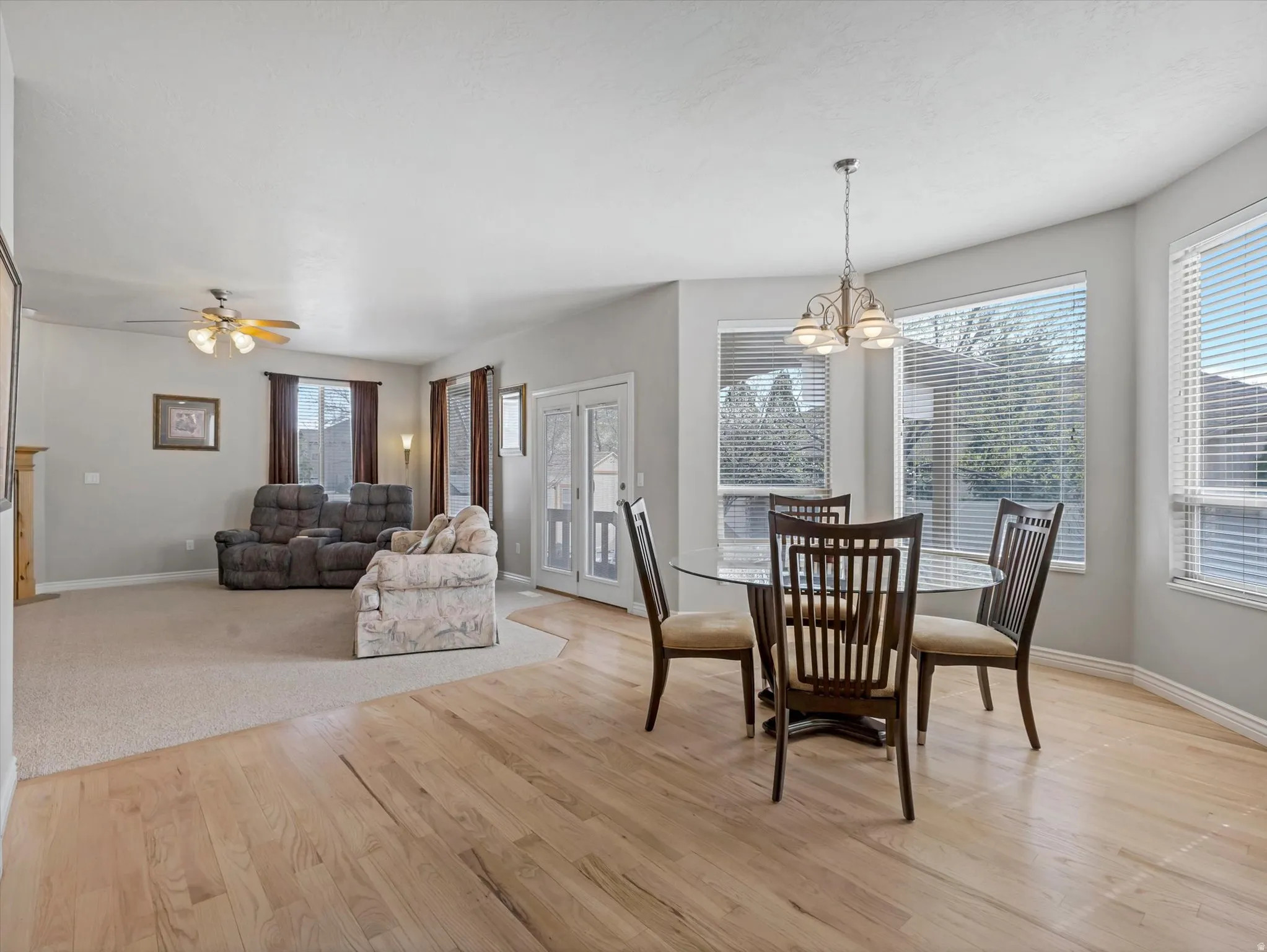 Dining area featuring light wood-type flooring, ceiling fan, and hanging lights
