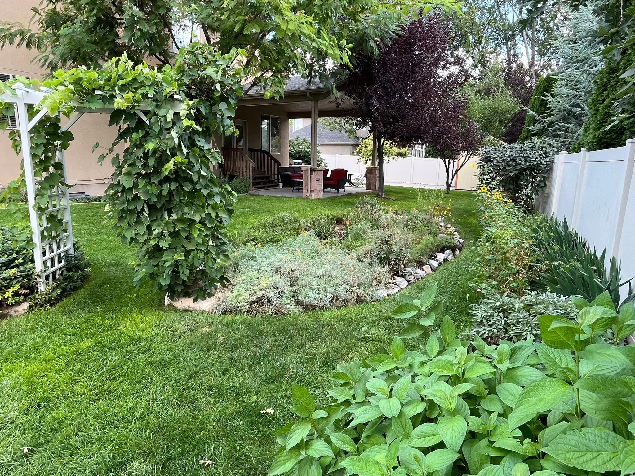Fenced backyard with a patio