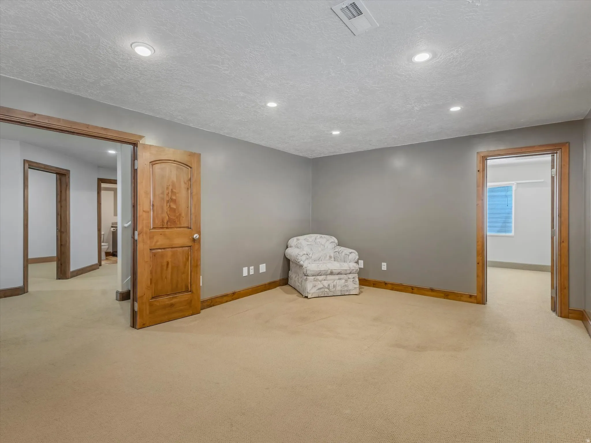 Unfurnished room featuring light colored carpet, recessed lighting, and a textured ceiling