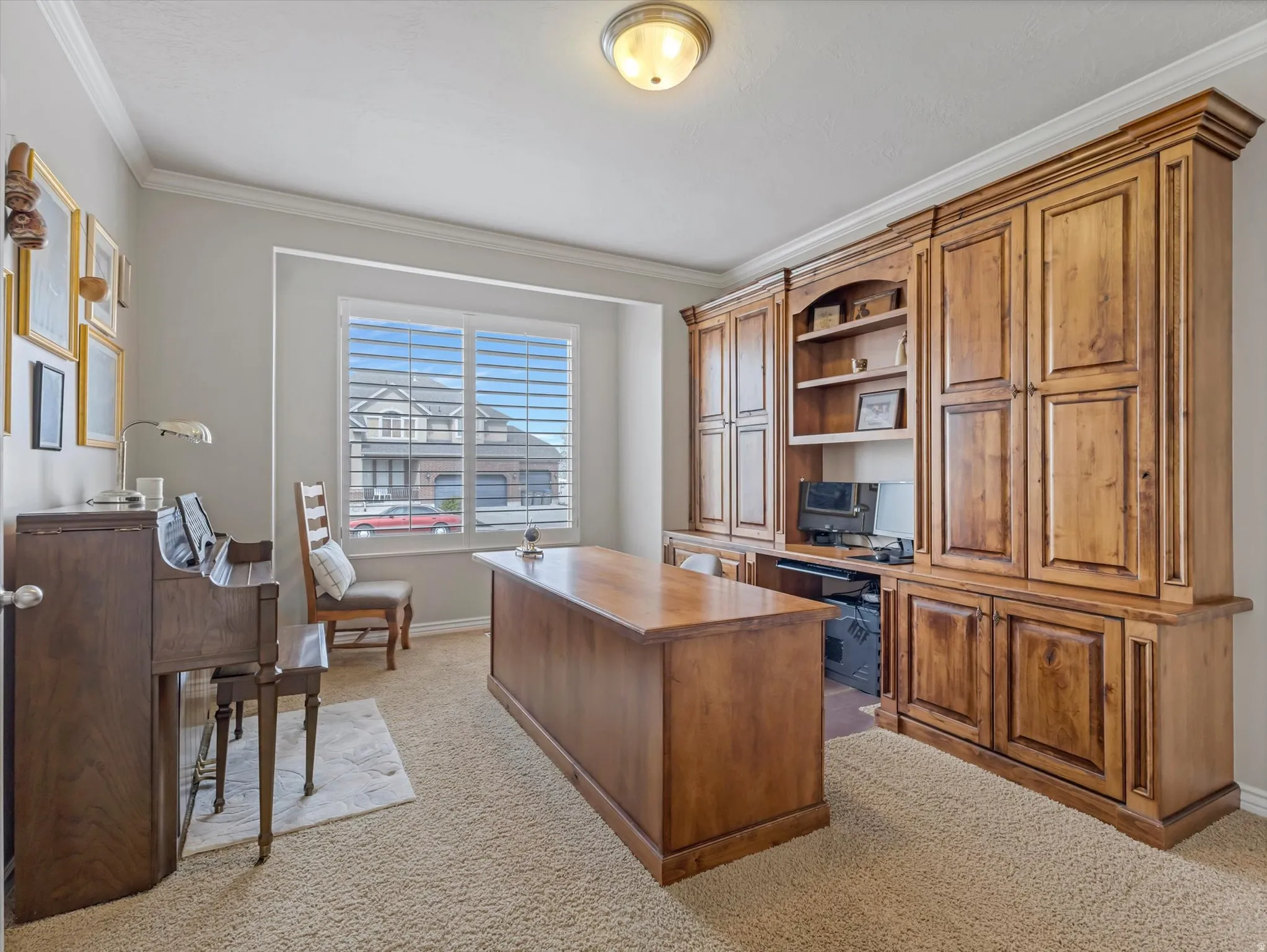 Office with light carpet and ornamental molding