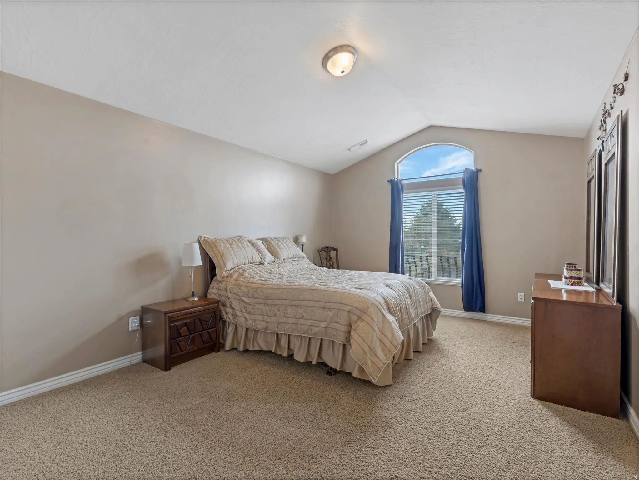 Bedroom with baseboards and light colored carpet