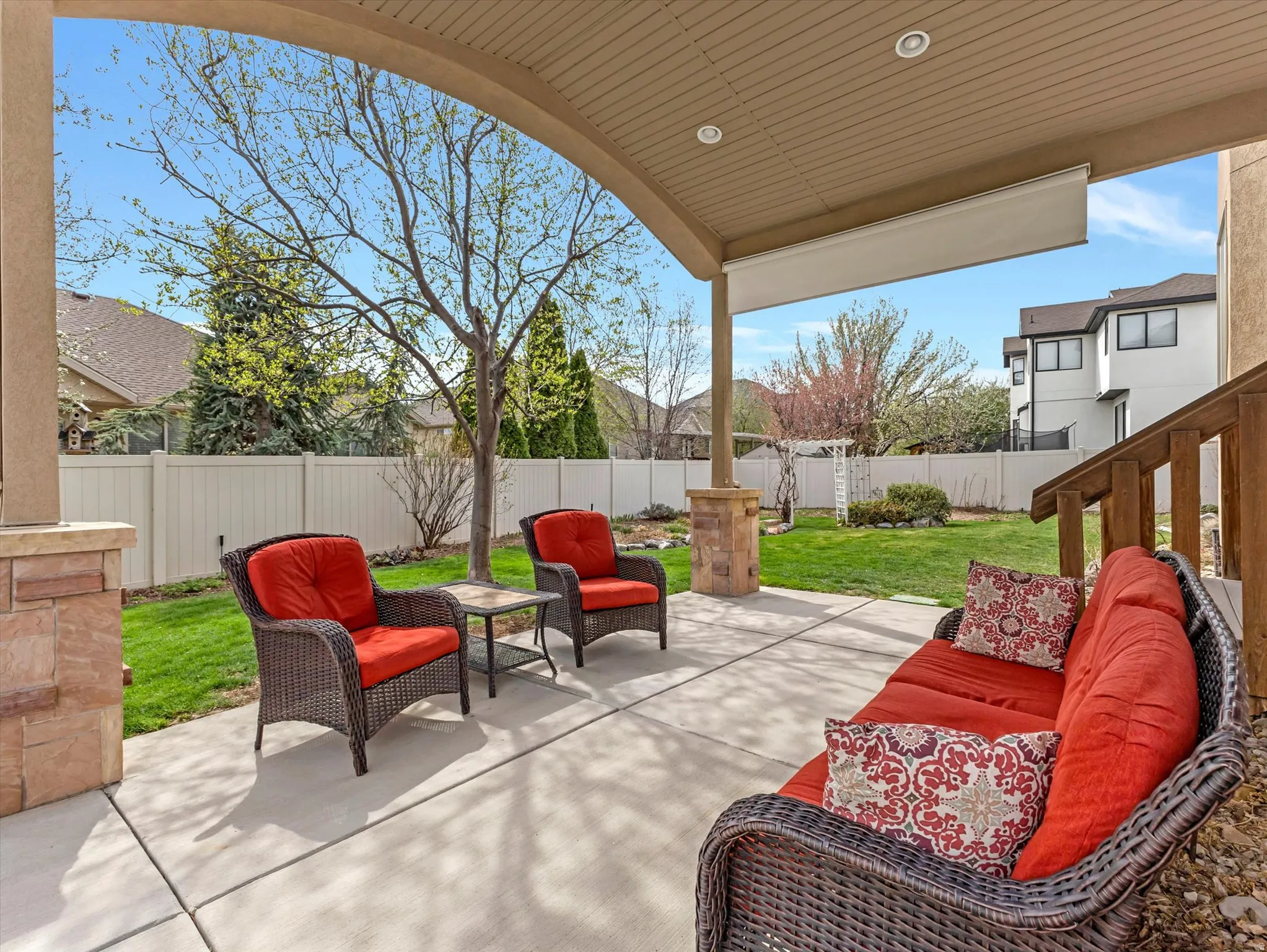 Fenced backyard with a patio and outdoor lounge area