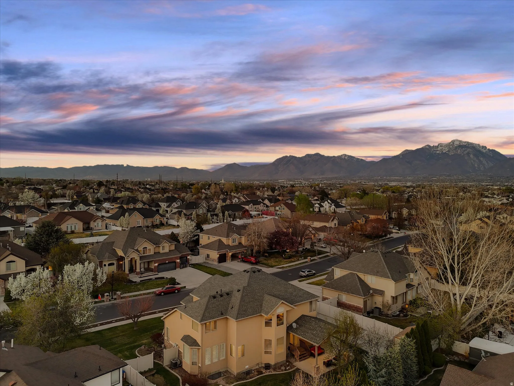 Aerial view at dusk of a residential view and a mountain view