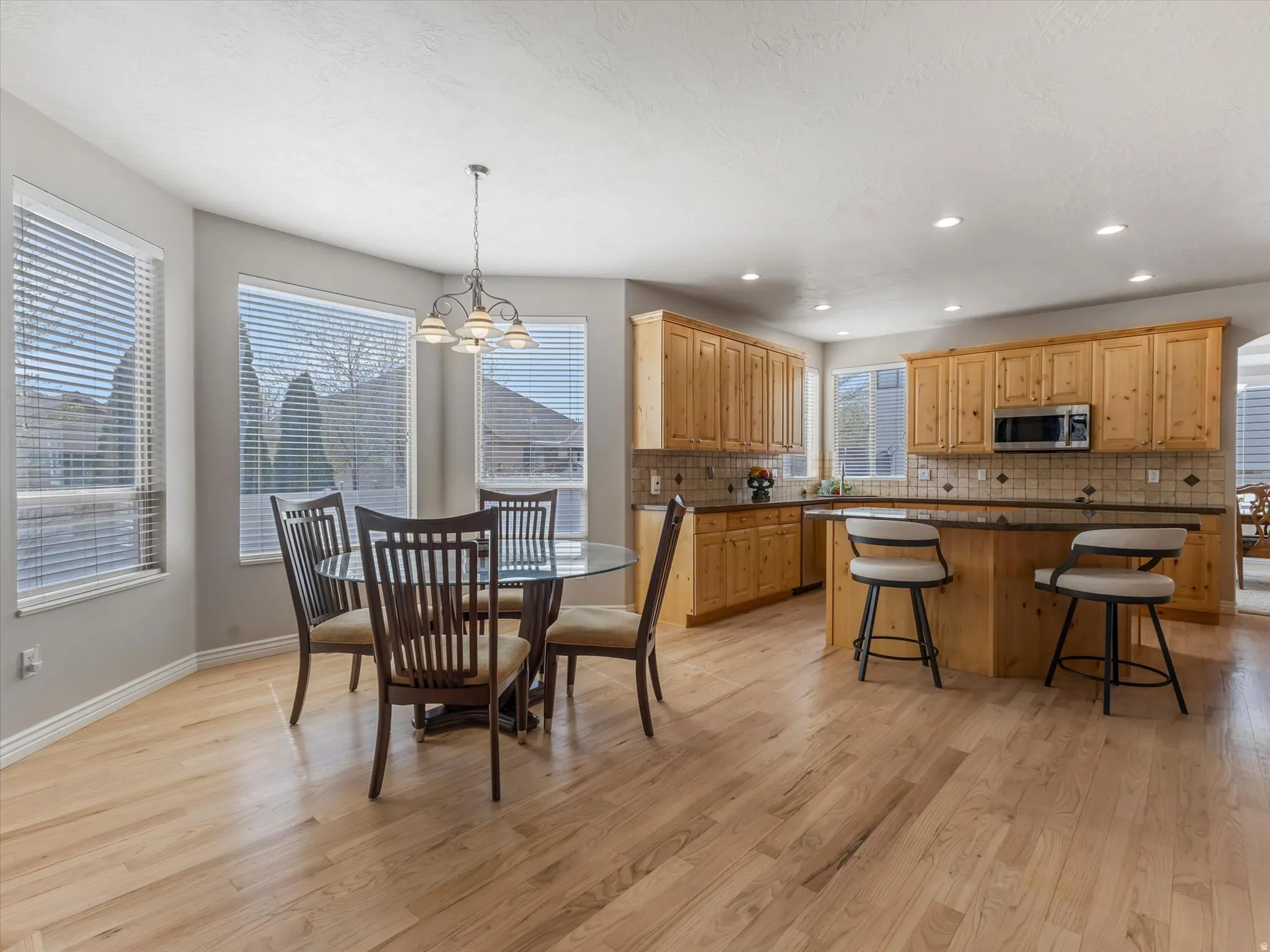 Dining room featuring light wood finished floors and a chandelier