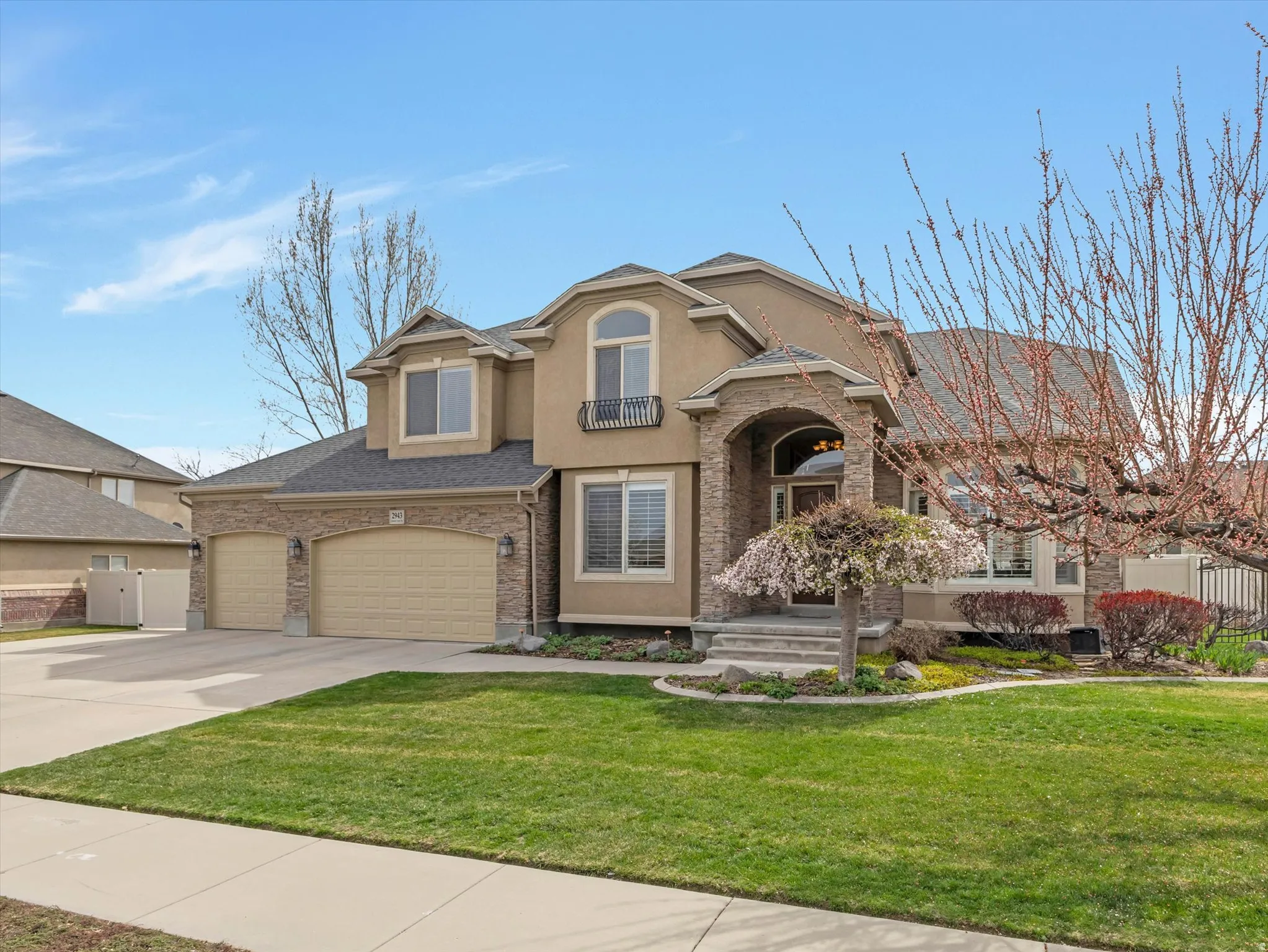 Traditional-style house featuring concrete driveway, stucco siding, and an attached garage