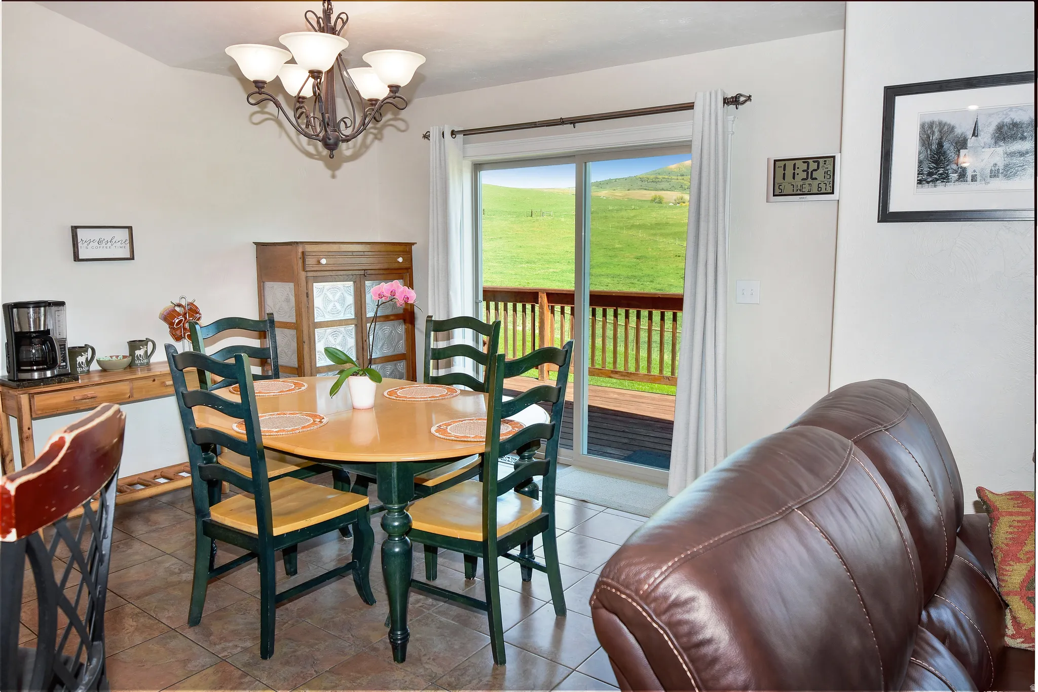Dining room with suspended lighting and tile patterned floors