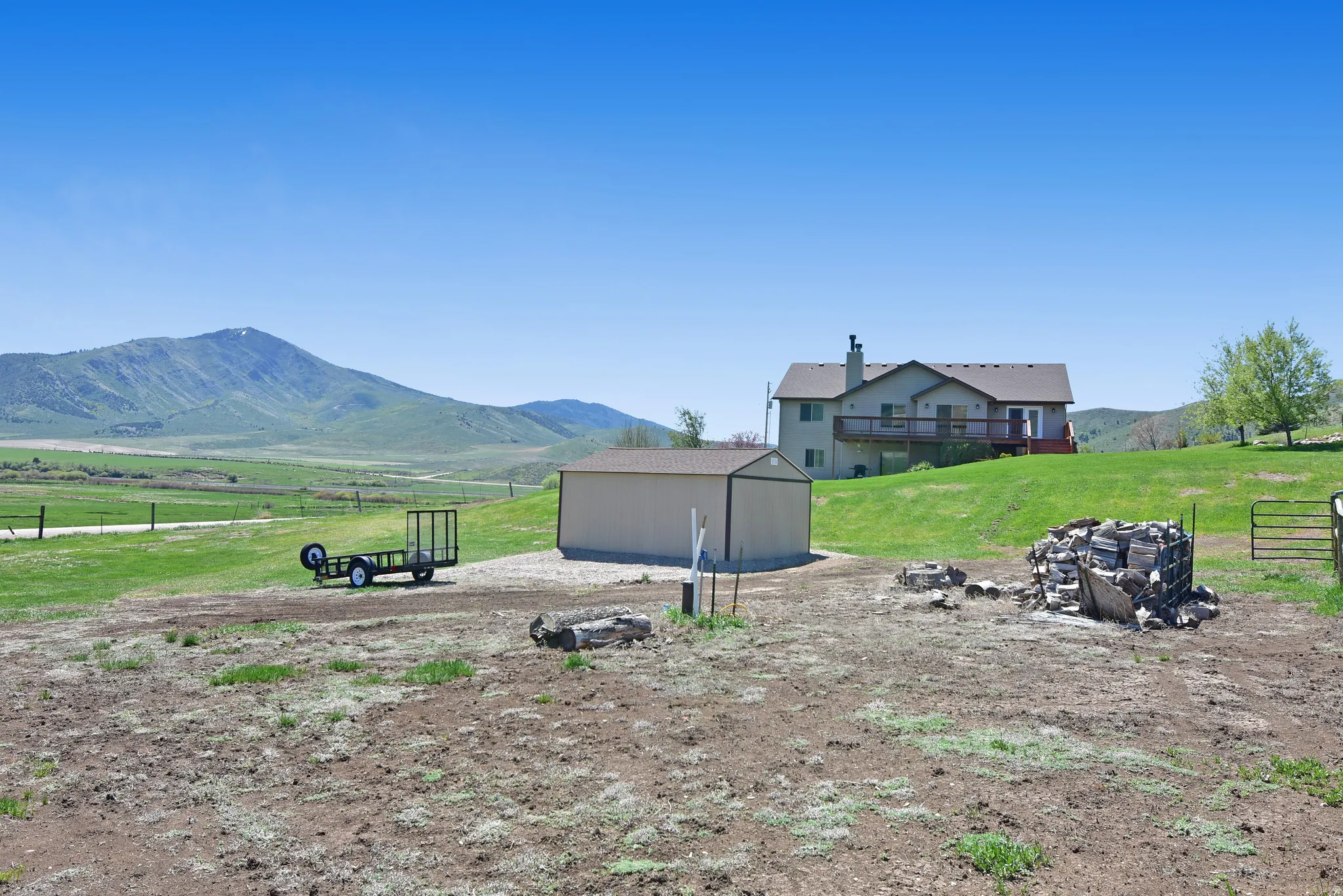 View of yard featuring an outdoor structure, a rural view, and a mountain view