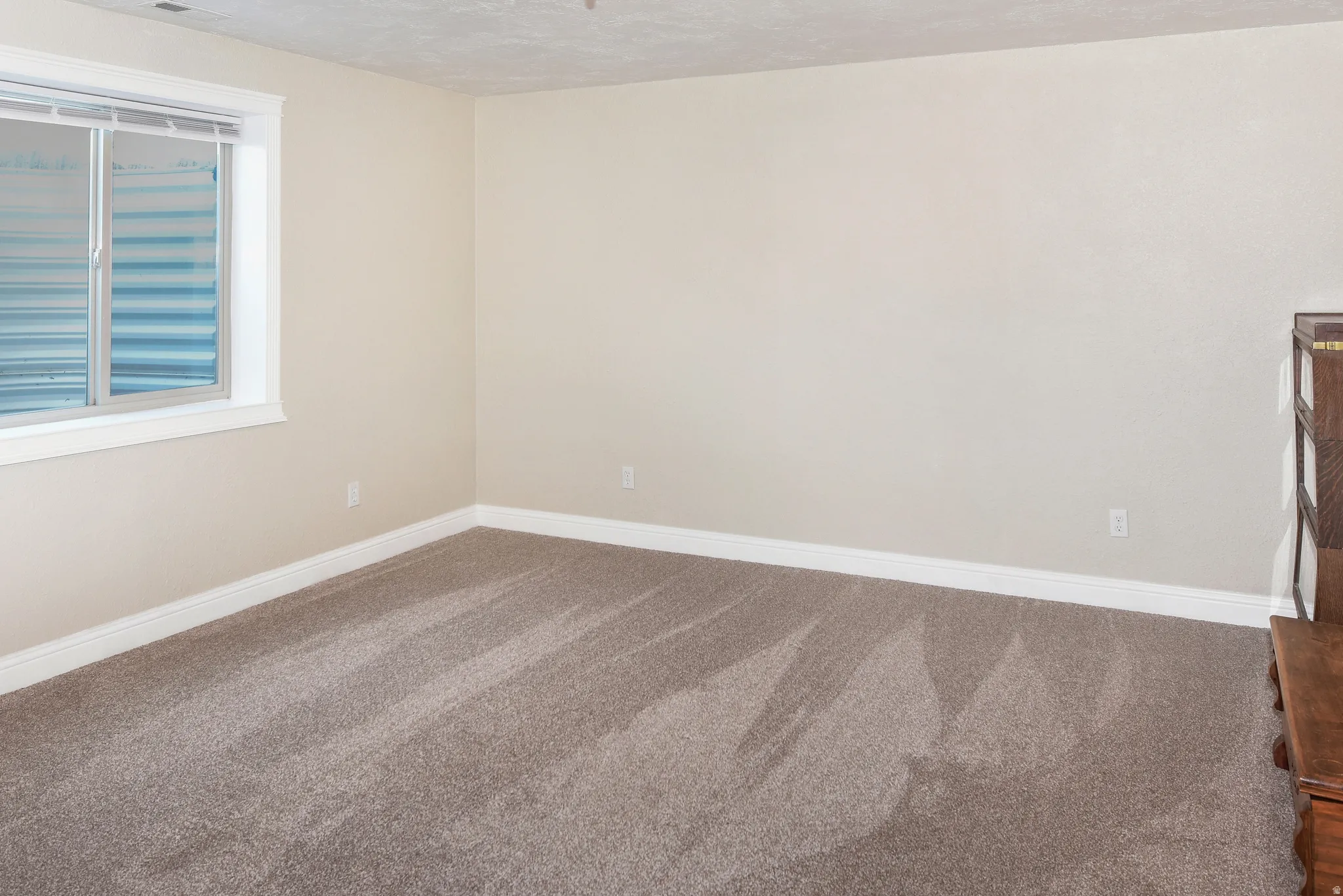 Unfurnished room with carpet flooring and baseboards